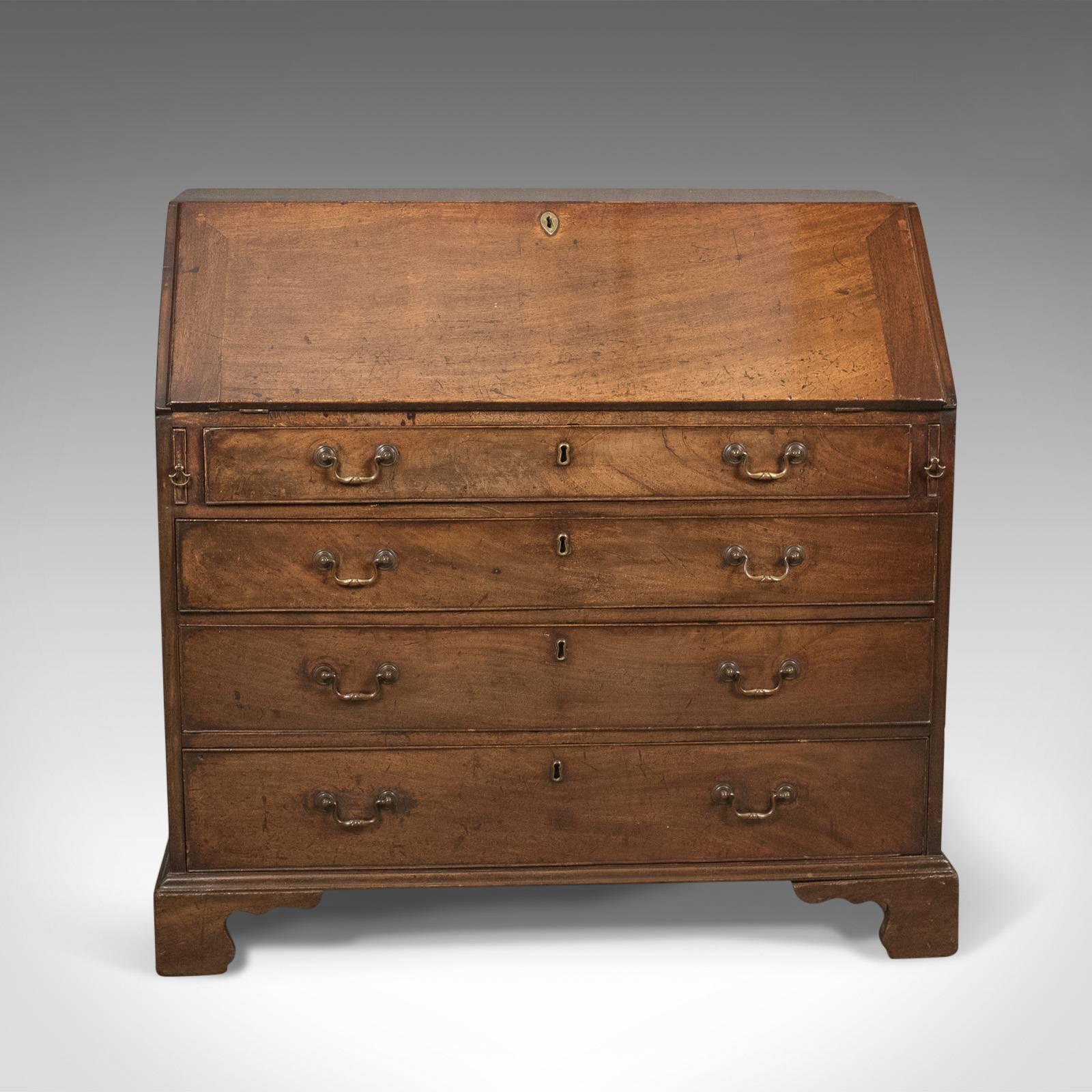This is a Georgian antique bureau, an 18th century mahogany desk dating to the reign of George III, circa 1770.

Mahogany with russet tones, grain interest and a desirable aged patina
Key and working lock to the fall, drawer key absent
Raised on