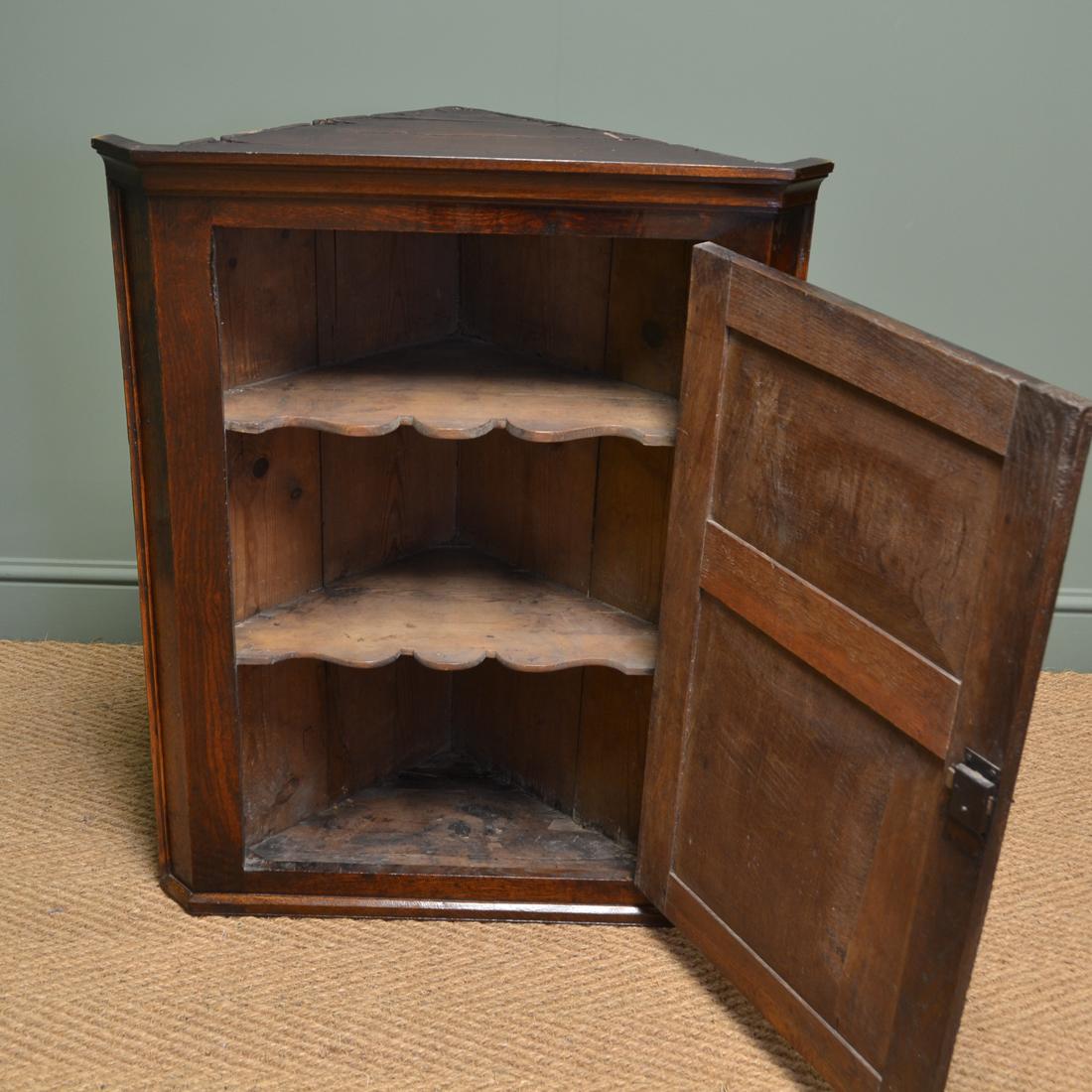Small Georgian antique oak hanging corner cupboard

Of lovely small neat proportions, this charming corner cupboard dates from around 1790. With a moulded cornice above a beautifully figured panelled door with key with working lock, the interior