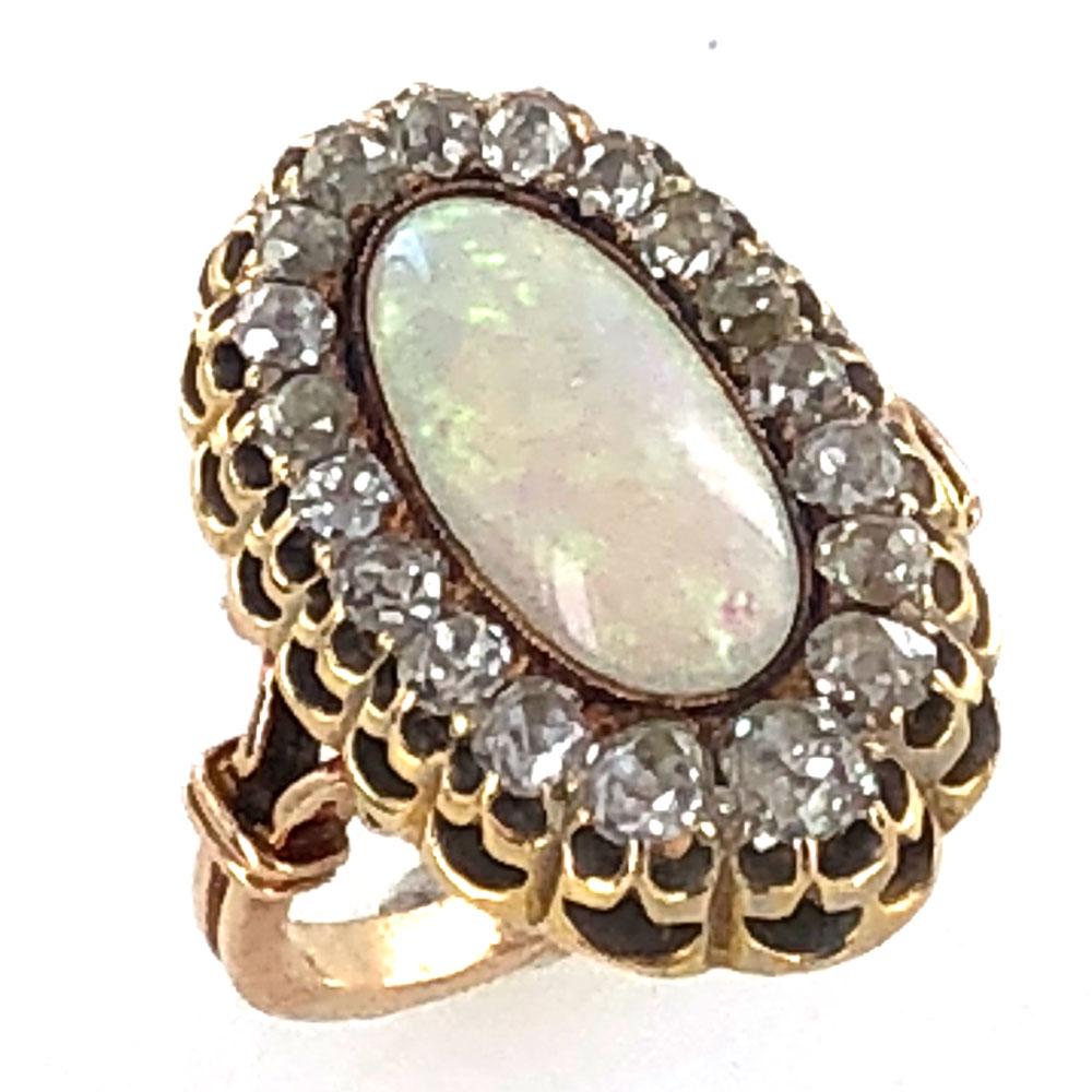 This beautifully preserved opal and diamond cocktail ring is circa mid-late 1800's. The opal is surrrounded by 20 Old Mine Cut Diamonds that equal approximately 1.50 carat total weight. Hand crafted in 14 karat yellow gold, the ring is currently