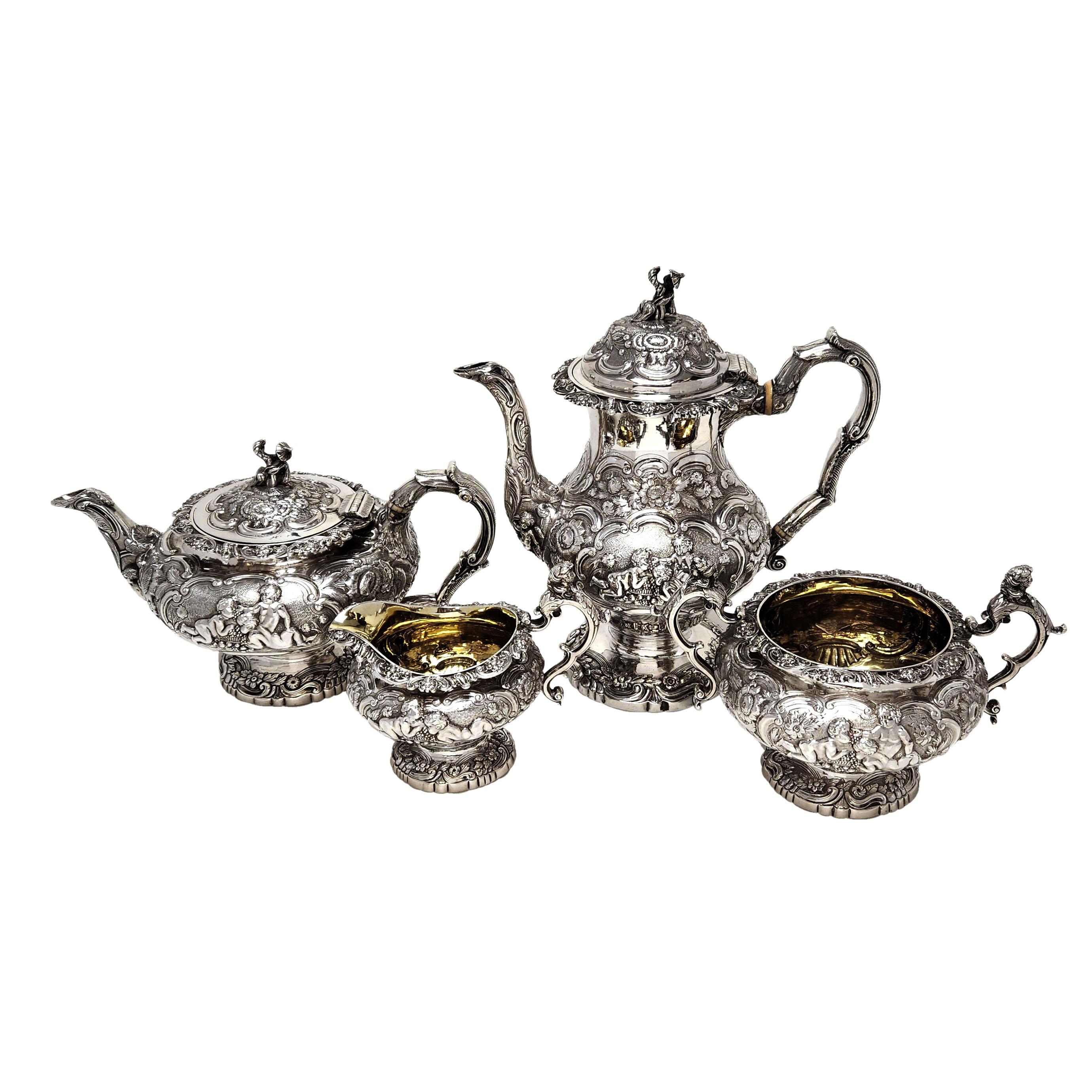 A beautiful antique George V sterling silver 4 piece Tea & Coffee Set comprising of a coffee pot, teapot, sugar bowl and milk / cream Jug. The pieces have a classic baluster shape. Each piece is emebellished with ornate chased designs including