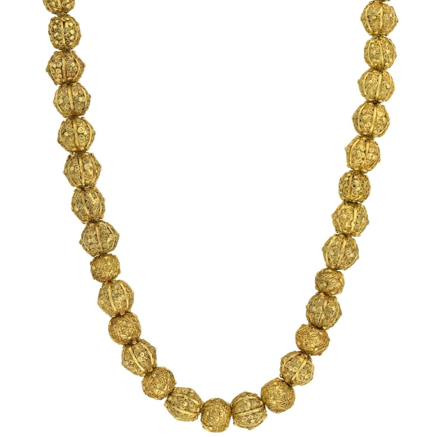 An exceptionally stunning and very rare bead necklace from the Georgian (ca1750) era! This vibrant 22kt yellow gold piece is comprised of 43 handwrought beads which are beautifully decorated with ornate surface wirework, and likely originates from a