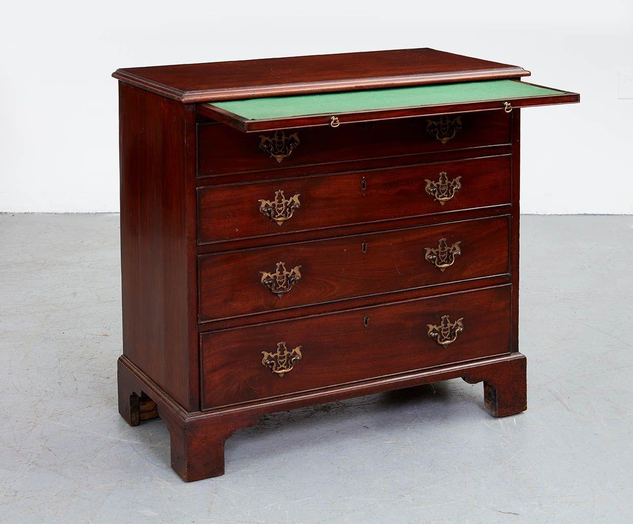 Good George III mahogany bachelor's chest, the top with ogee molded edge over green cloth lined brushing or writing slide, over four graduated drawers and standing on well-drawn bracket feet, the whole with mellow pleasing color. Pierced brasses