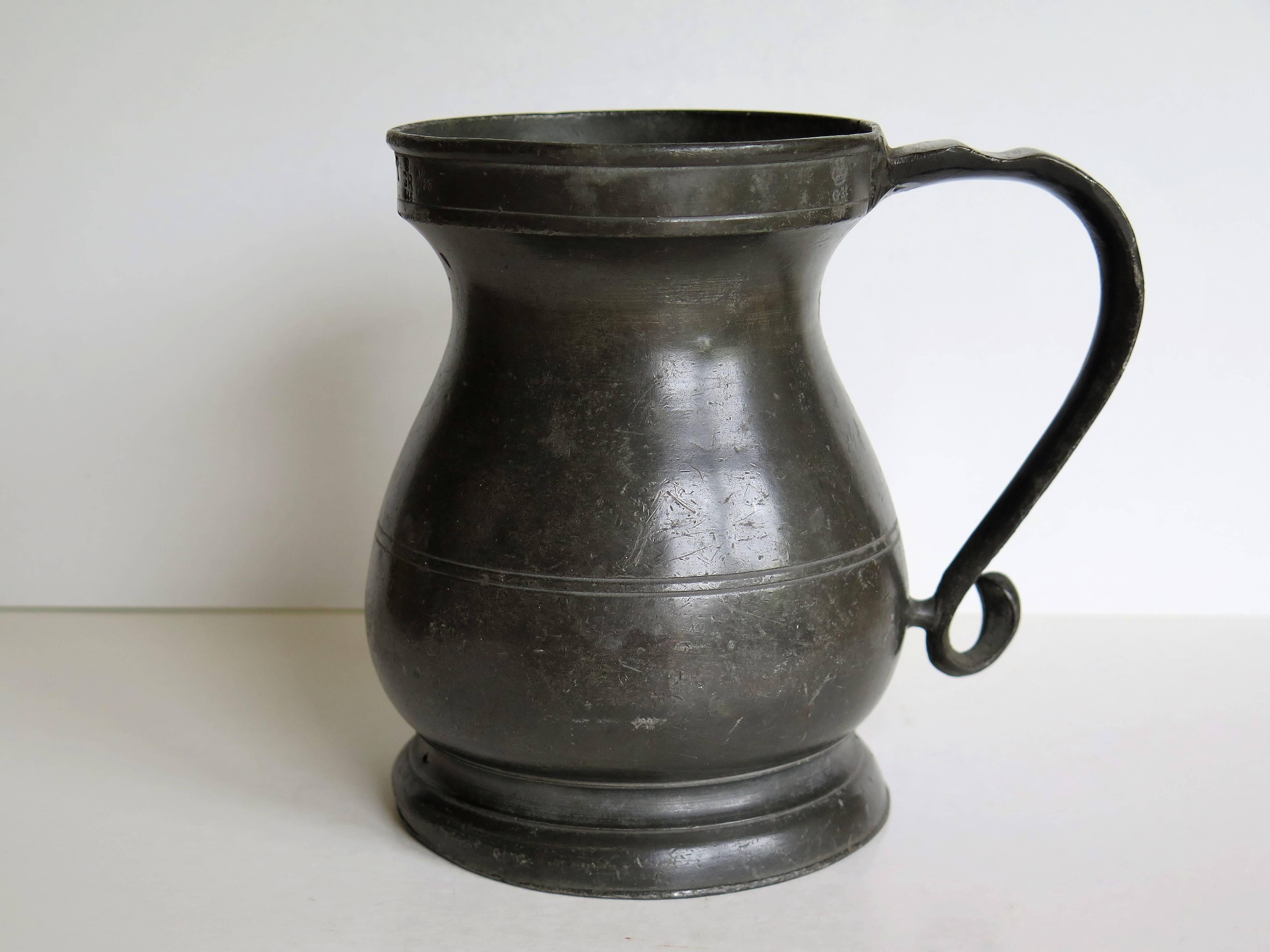 This is a good mid-18th century pewter tankard or mug with a baluster shape, fully stamped with GR and other markings.

This tankard has a lovely baluster pear shaped body on a flared skirt base and fairly deep top rim. The body has a double scribed