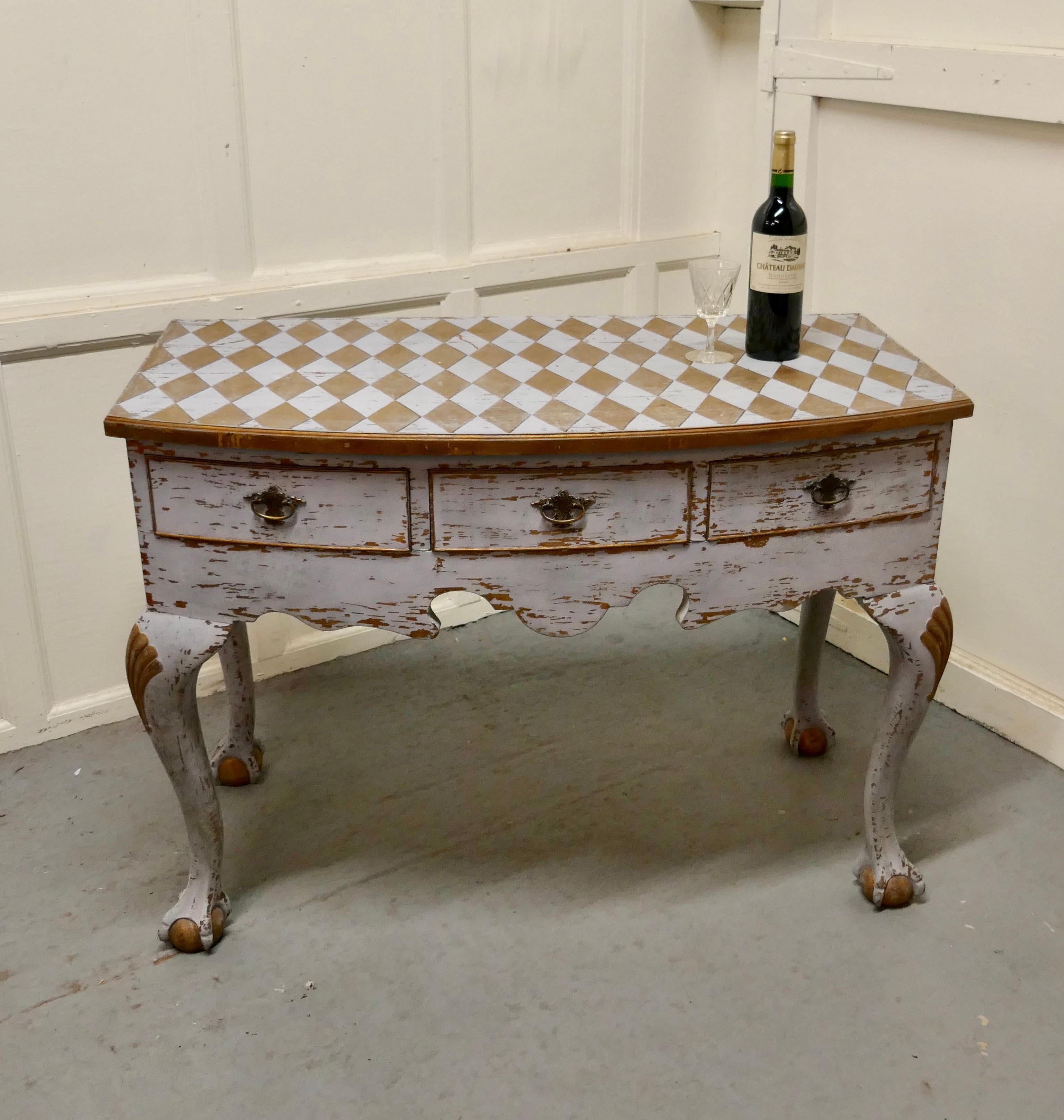 Georgian Baroque Bow Front Painted Console Side Table

A Unique piece, the table dates from around 18oo, it is decorated in Harlequin, the table stands on chunky cabriole kegs and has 3 drawers to the bow front
The table has distressed finish in