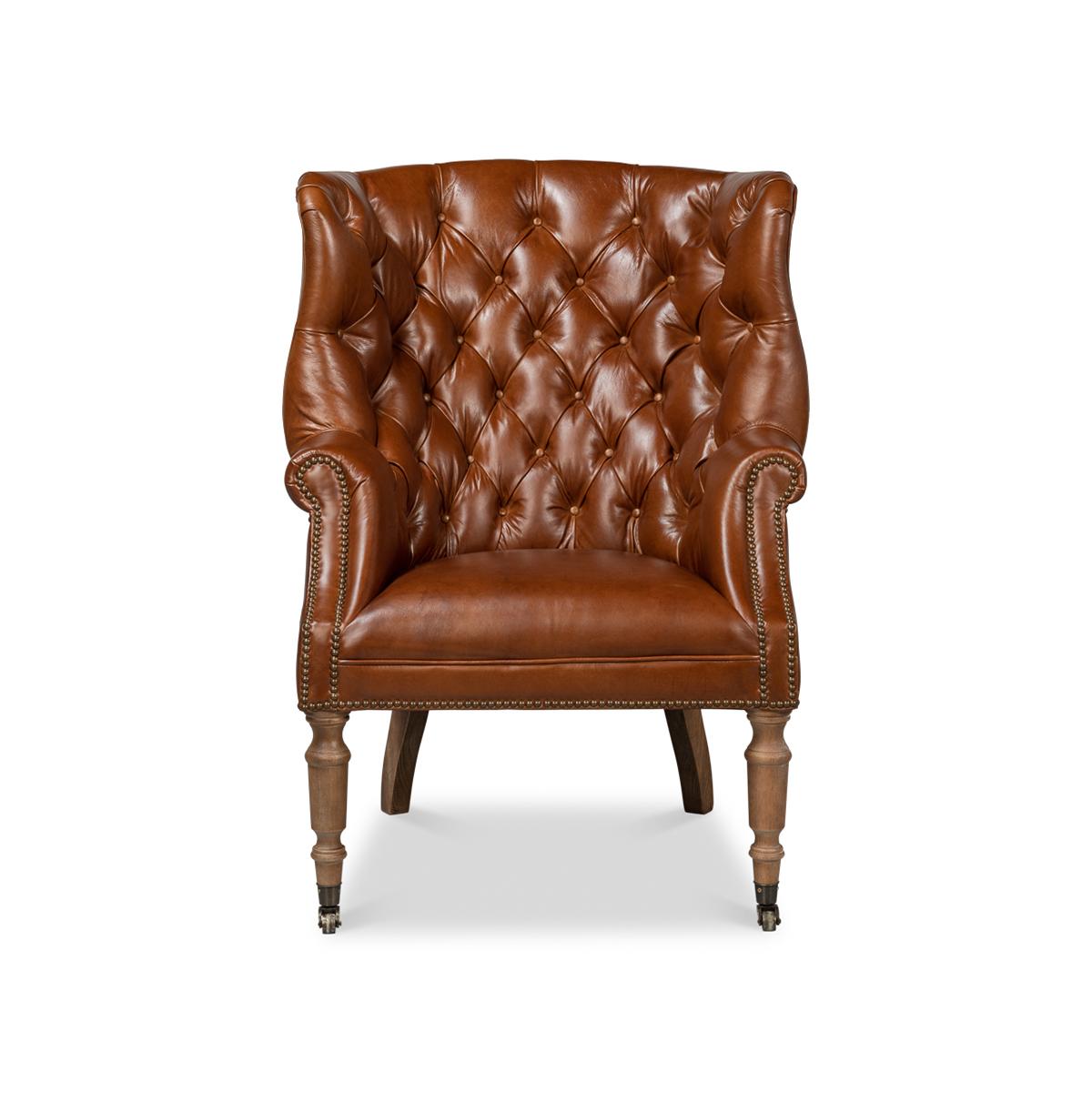 A wonderful George III style barrel back wingchair with top-grain Vintage Havana Leather, a tufted upholstery barrel backrest with winged sides, rolled arms and a padded seat. Finished with brass nailhead trim and raised on cerused turned front legs