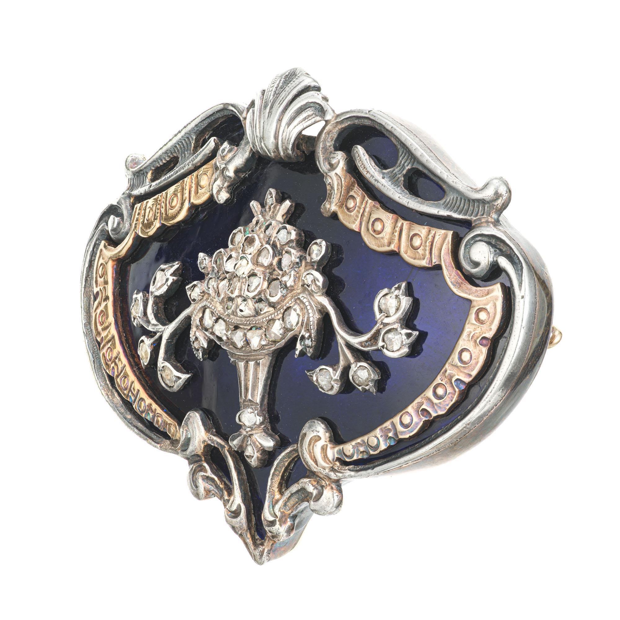 Handmade early 1800's Georgian brooch with hand engraving, rose cut diamonds set in silver on 14k gold. Blue enamel background and floral design. 

36 rose cut diamonds, approx. total weight .15cts, H-I, SI - I
14k Yellow gold
24.3 grams
Tested: 14k