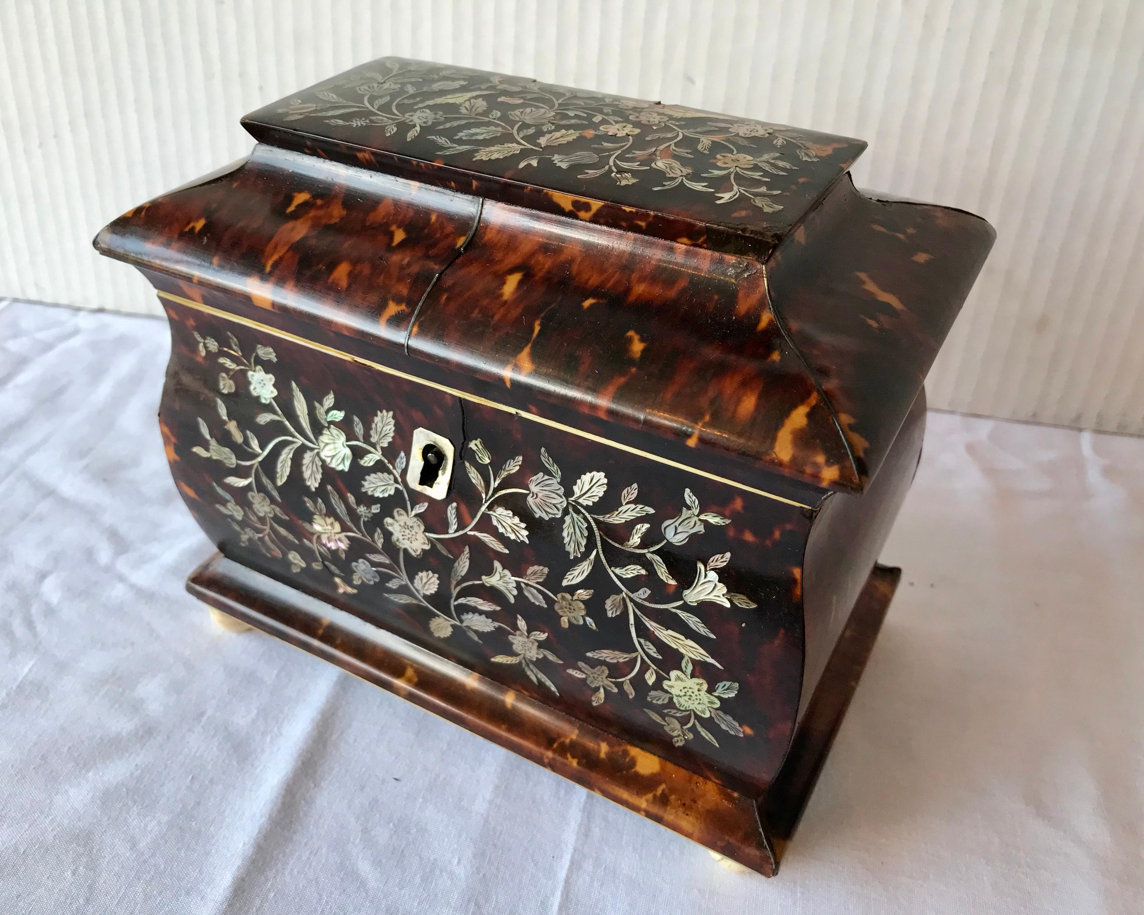 An extremely fine and rare form. The caddy is generously scaled and exquisitely inlaid with 
mother - of - pearl florals with birds. Interior lids are original.