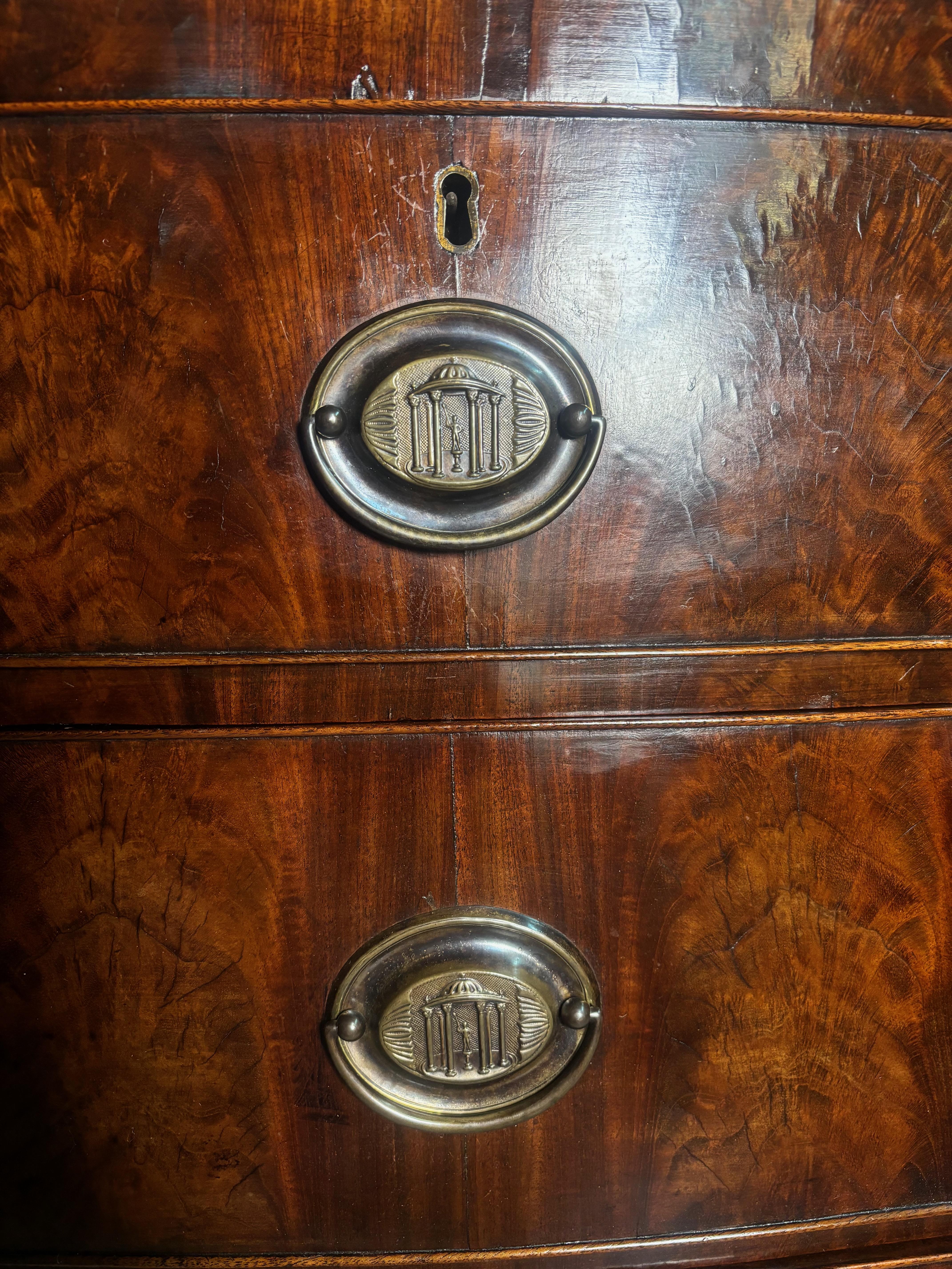Feathered Mahogany.
Compromising of 2 small and 3 large cock-beaded drawers. A very good bow fronted chest. All drawers run well. They have dust panels which prevents dust from running into the underside of the bottom drawers. 
The interior wood are