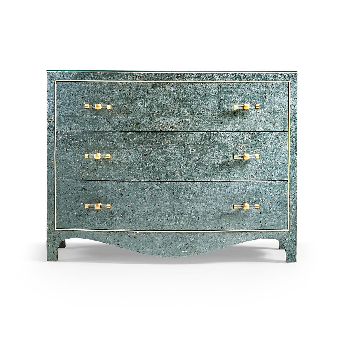 This unique piece showcases a dynamic teal cork wallpaper finish speckled with golden flecks, creating a textural delight that mimics the serene beauty of sea foam. A sleek, recessed glass top provides a stable and stylish surface for lamps, books,