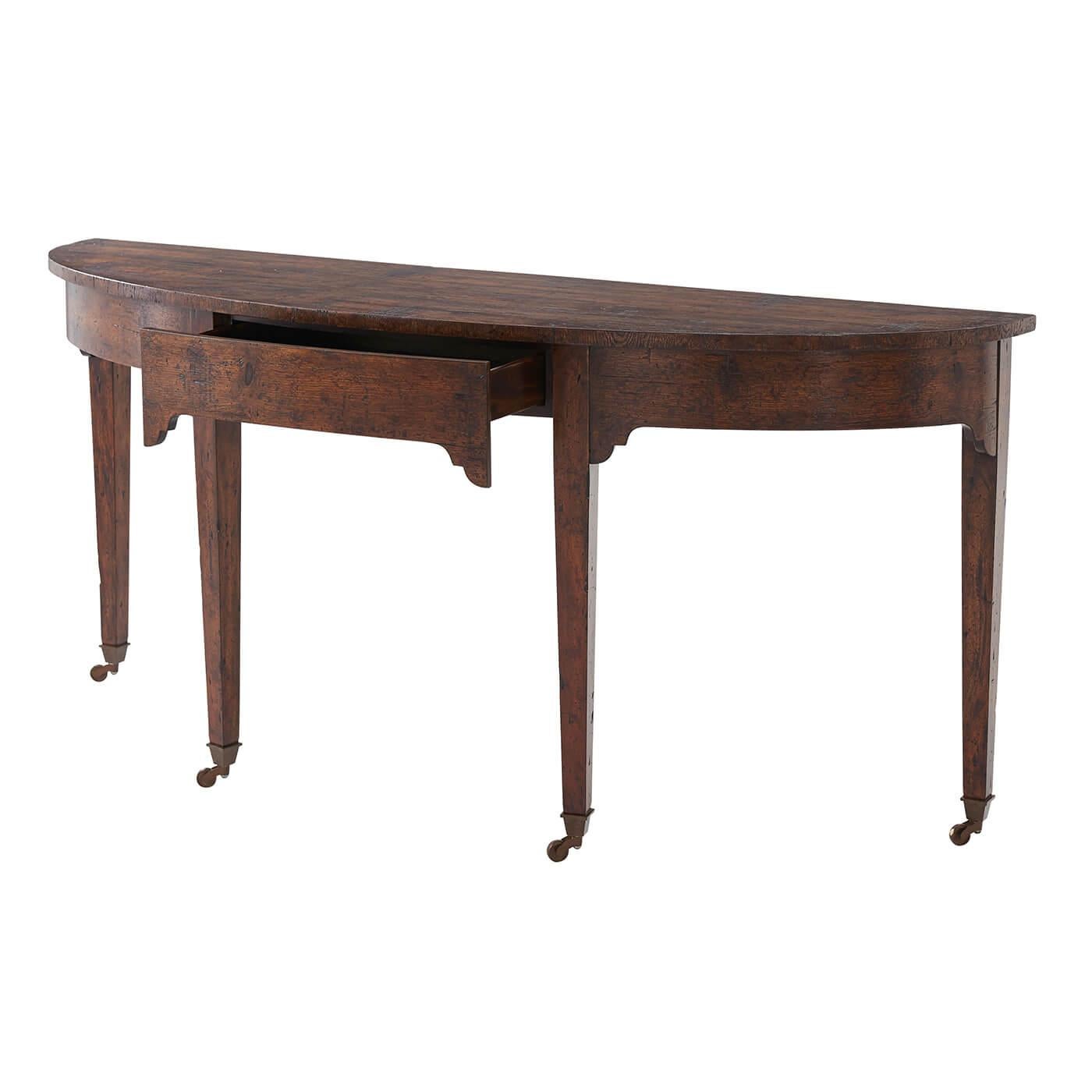 A Georgian style mahogany and reclaimed oak console table, the bowfront top above a plain frieze with drawer and corner brackets, on tapering legs terminating in brass castors.
Dimensions: 72.5