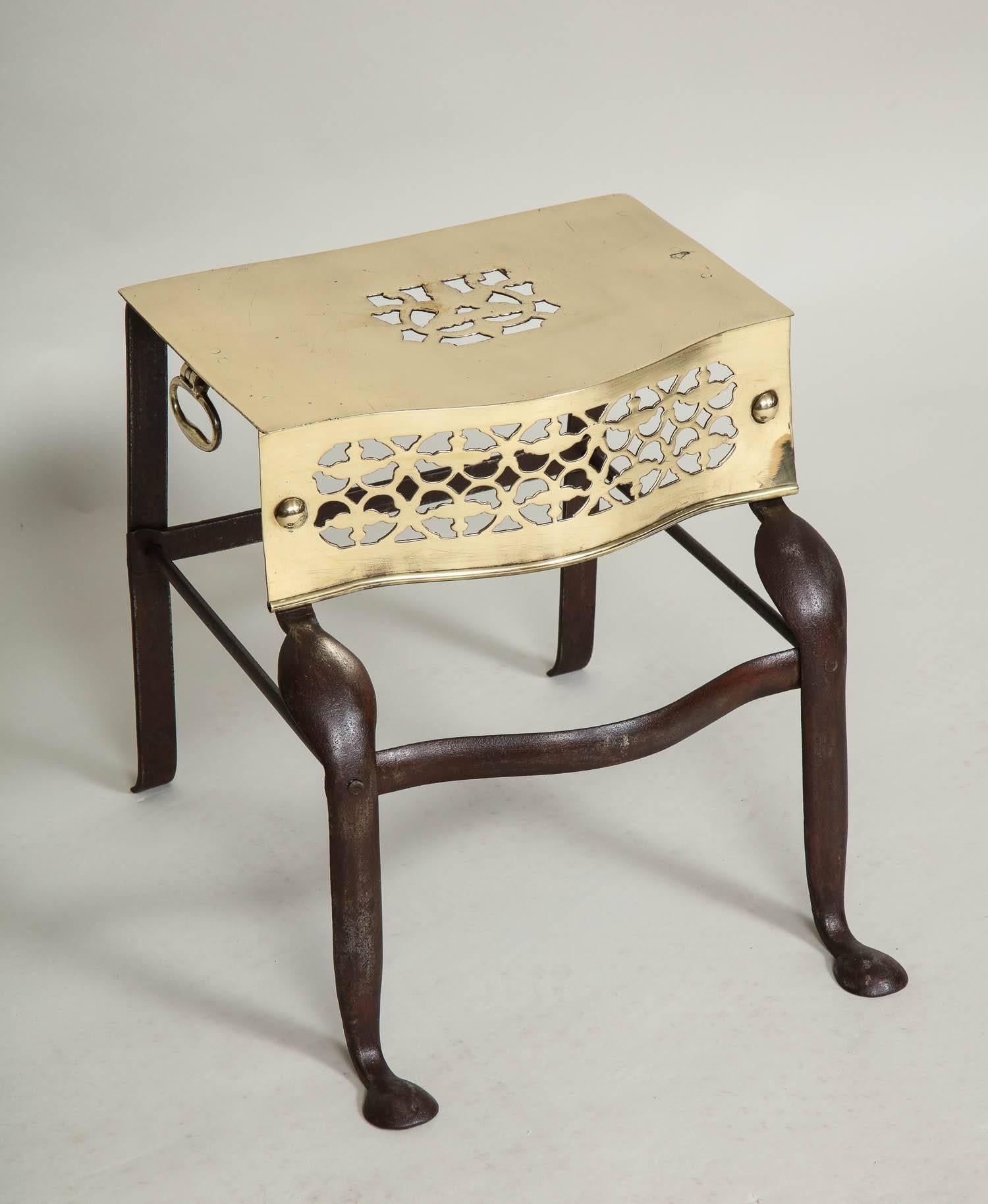 Fine George III period trivet having pierced brass top, frieze and handles over gunmetal steel base, the front cabriole legs ending in penny feet.