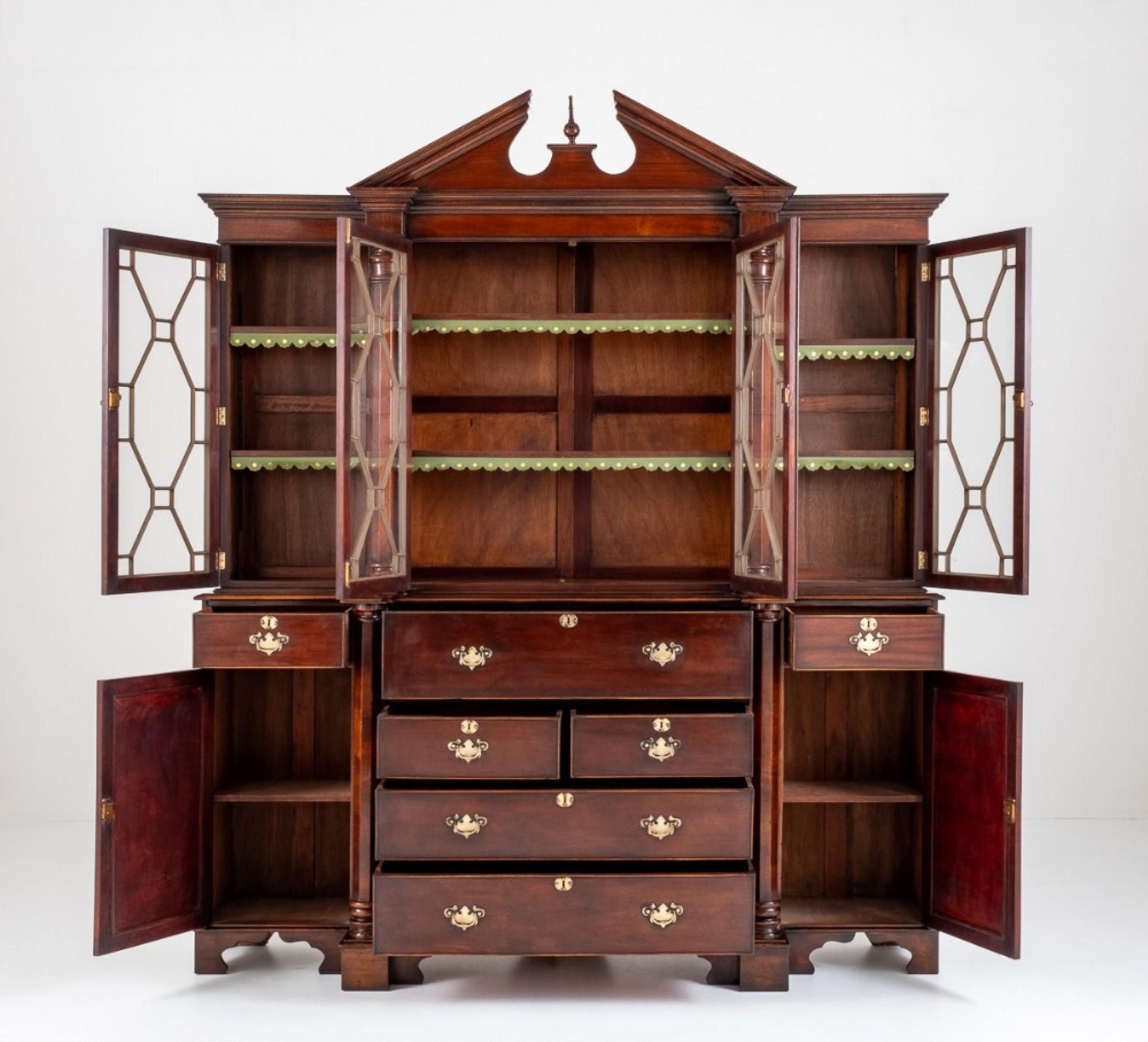 Georgian Revival mahogany breakfront bookcase.
circa 1880
This bookcase stands upon bracket feet, having a centre section featuring 2 over 2 mahogany lined drawers with a secretaire to the top drawer.
The secretaire having pigeon holes, drawers
