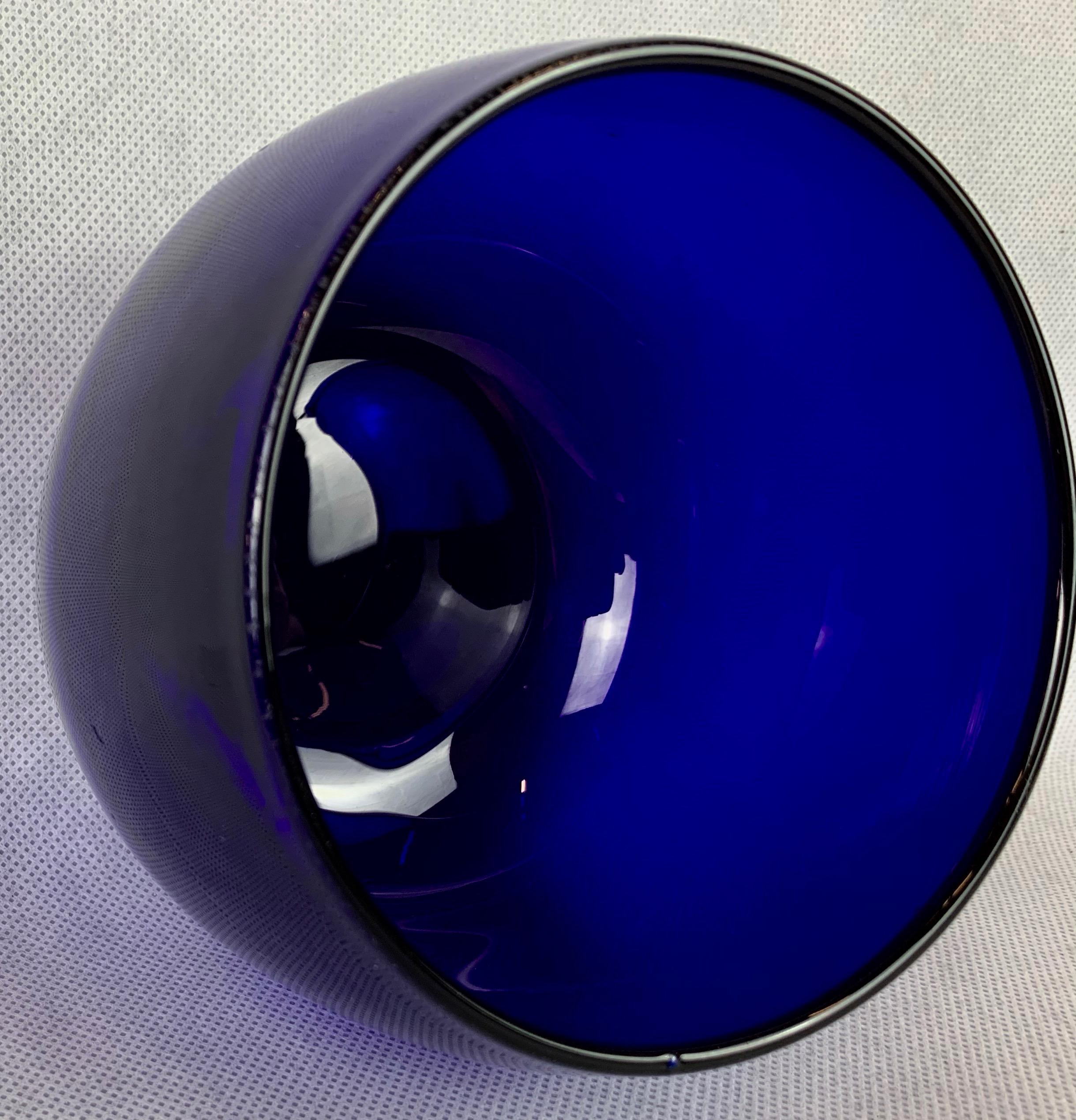 Large hefty hand blown Georgian Bristol blue finger bowl. Smooth sided while slightly curving towards the top rim. The base has a generous polished pontil exhibiting evidence of the glass blowers artistry. The bowls can be wonderfully repurposed to