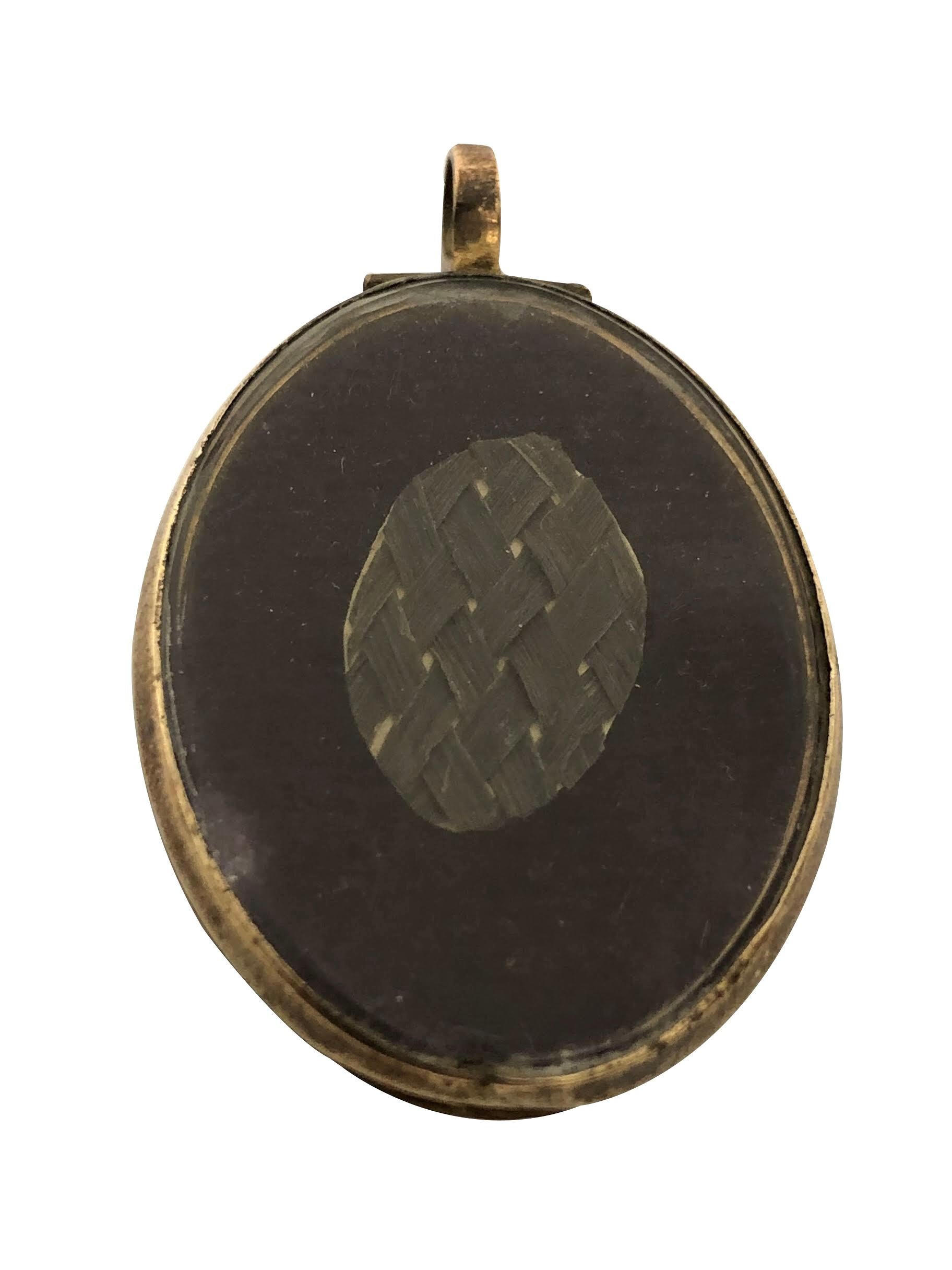 Circa 1800 Yellow Gold and Hand Painted Memorial Locket with a Depiction of Britannia, this piece measures 1 3/4 X 1 1/8 inch, original glass covers both side of the locket that opens with a back side compartment having a piece of  finely woven