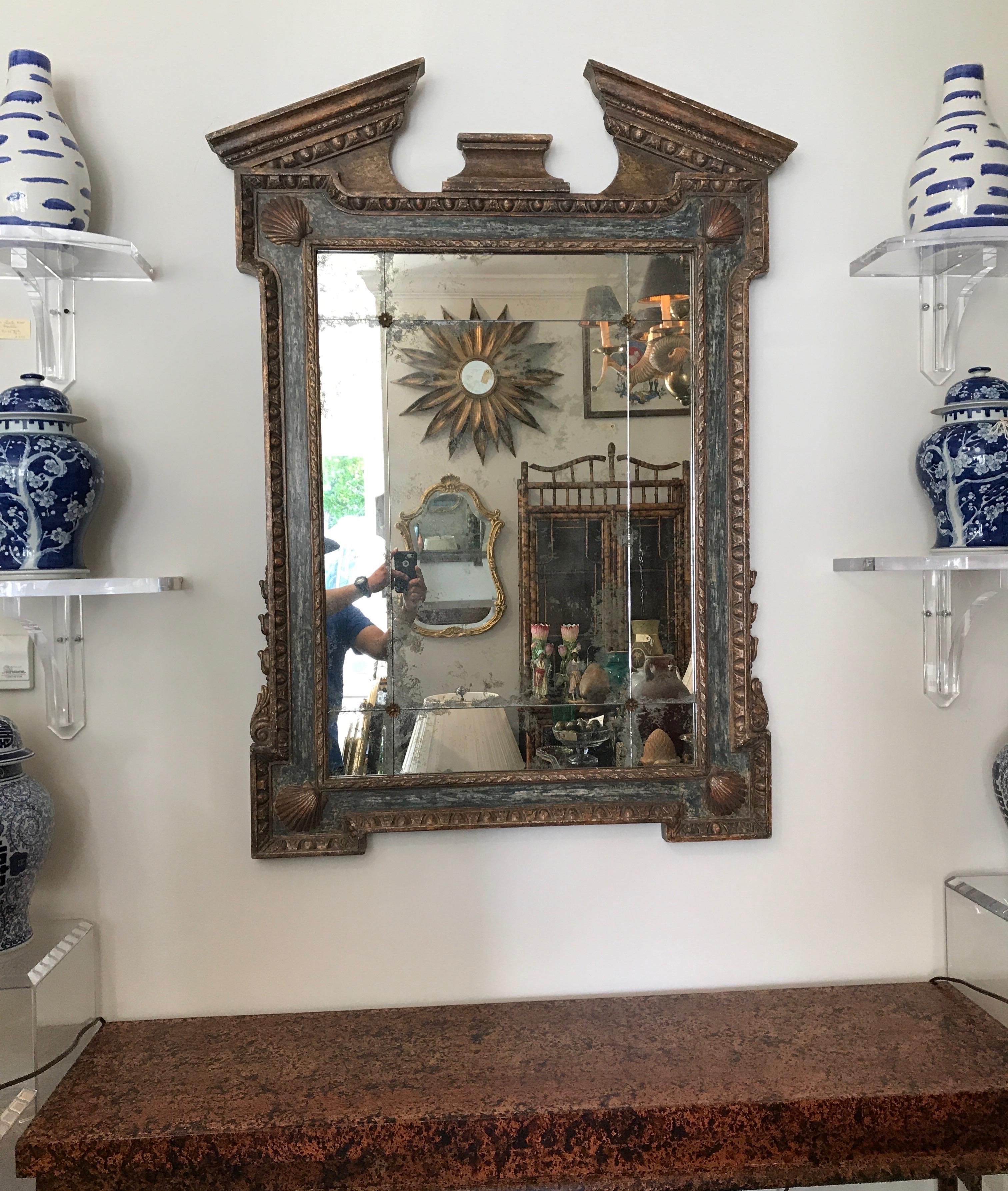 Painted broken pediment mirror adorned with seashells in each corner.