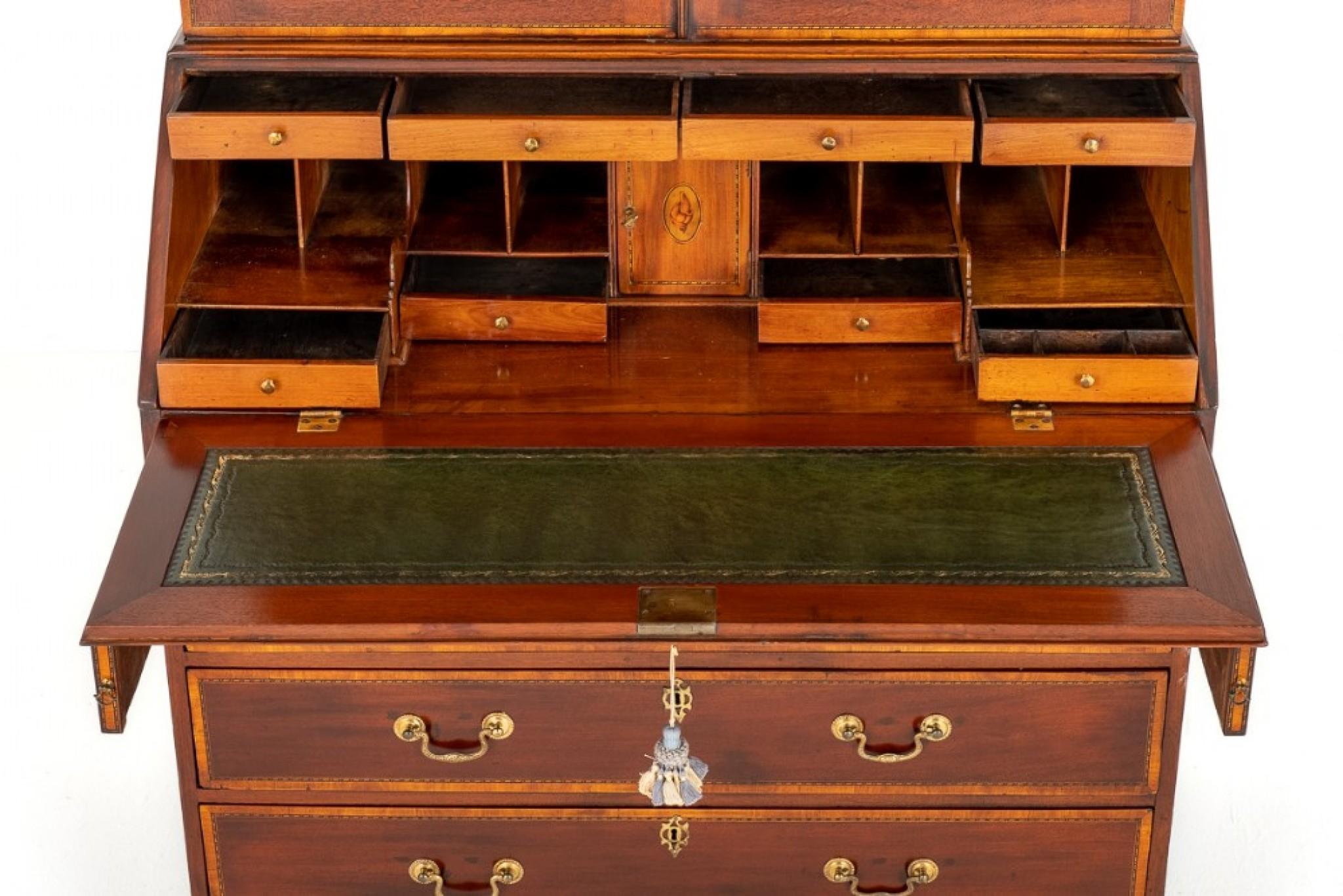 Georgian Mahogany Bureau Bookcase.
Circa 1800
The Base Having an Arrangement of 2 Over 3 Oak Lined Drawers With Brass Swan Neck handles.
The Fall Opens to Reveal a Leather Writing Surface (replacement) with hand Applied Gilt and Blind Tooling and