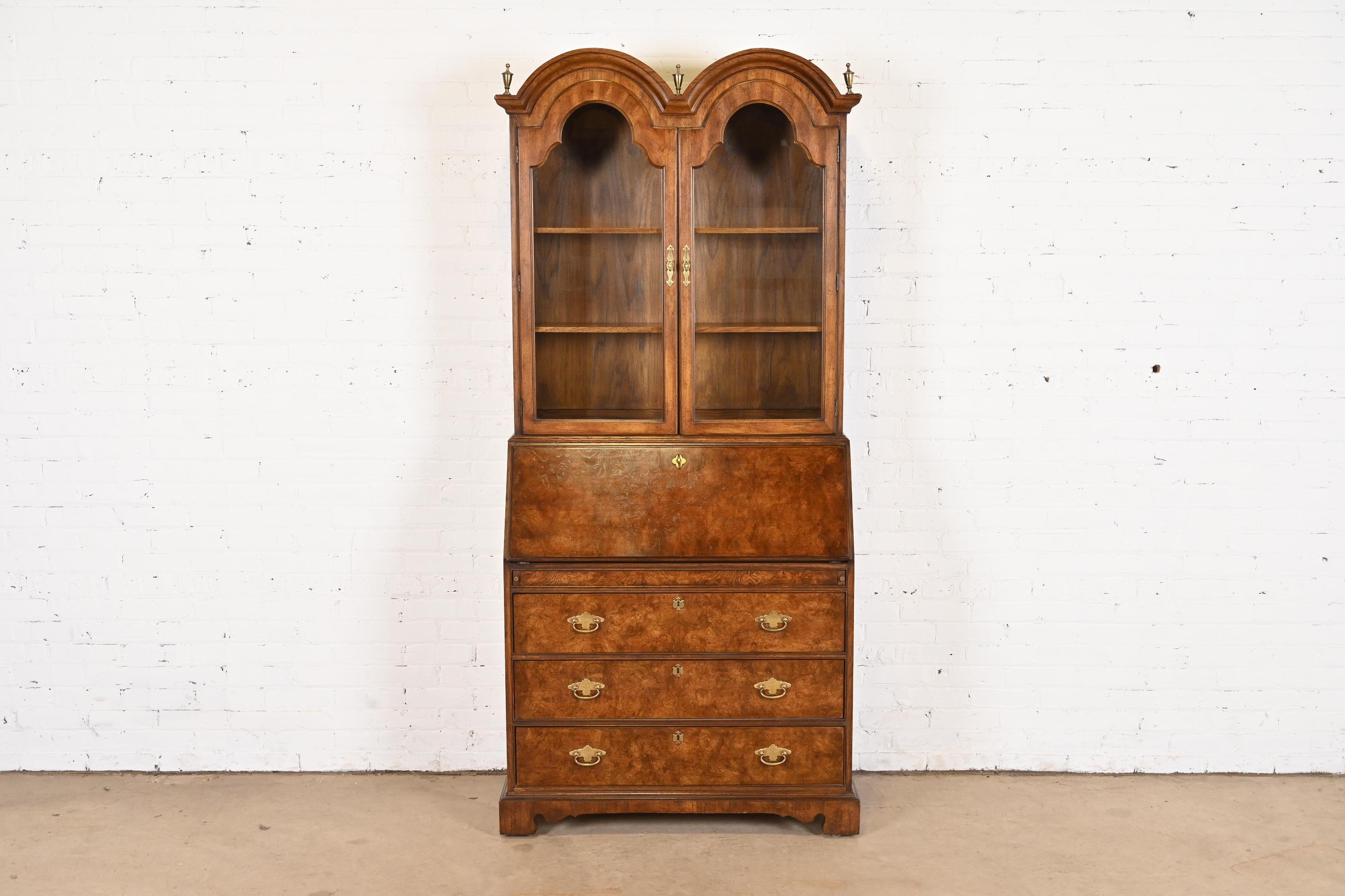 A beautiful Georgian or Queen Anne style bureau with drop front secretary desk and bookcase hutch top

By National Mt. Airy Furniture

USA, Circa 1980s

Gorgeous figured burled walnut, with original brass hardware and glass front doors.

Measures: