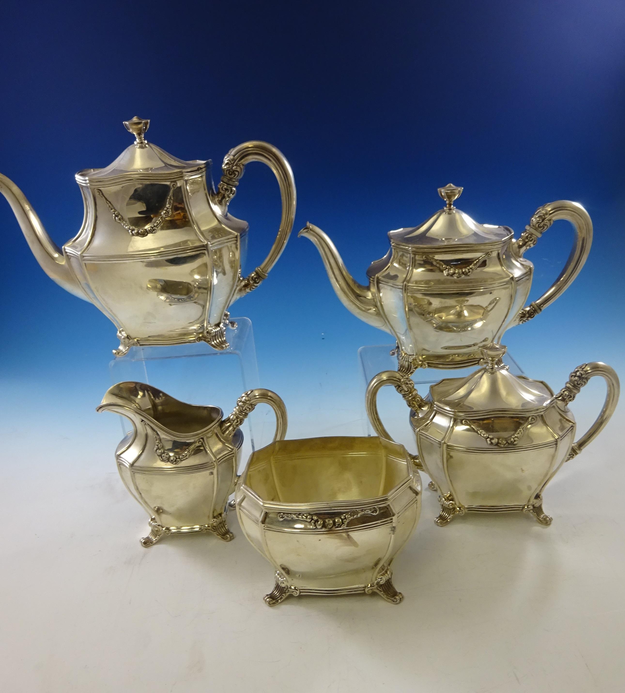 Georgian by Towle
Superb 5-piece Georgian by Towle sterling silver tea set. It is decorated with columnar feet and applied swag with flowers. The set includes:

Measures: Coffee pot: Measures 8 tall, 11 wide, and it weighs 29.7 ozt.
Tea pot: