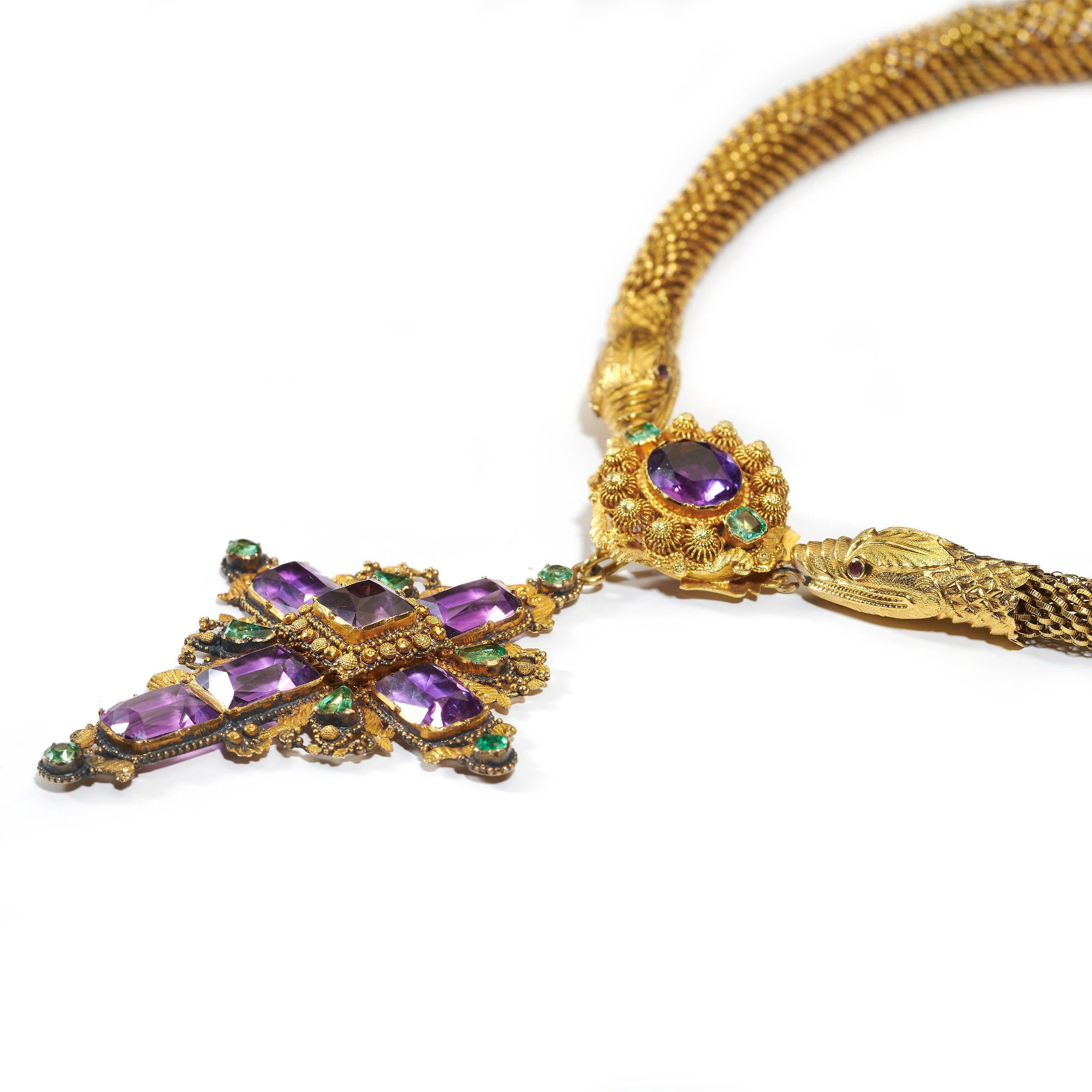 A Georgian cannetille snake necklace, with an amethyst and emerald cross pendant; with the snake chain worked in fine, flexible cannetille wire link work, with embossed snake heads at either end, set with faceted rubies, for the eyes; the snakes are