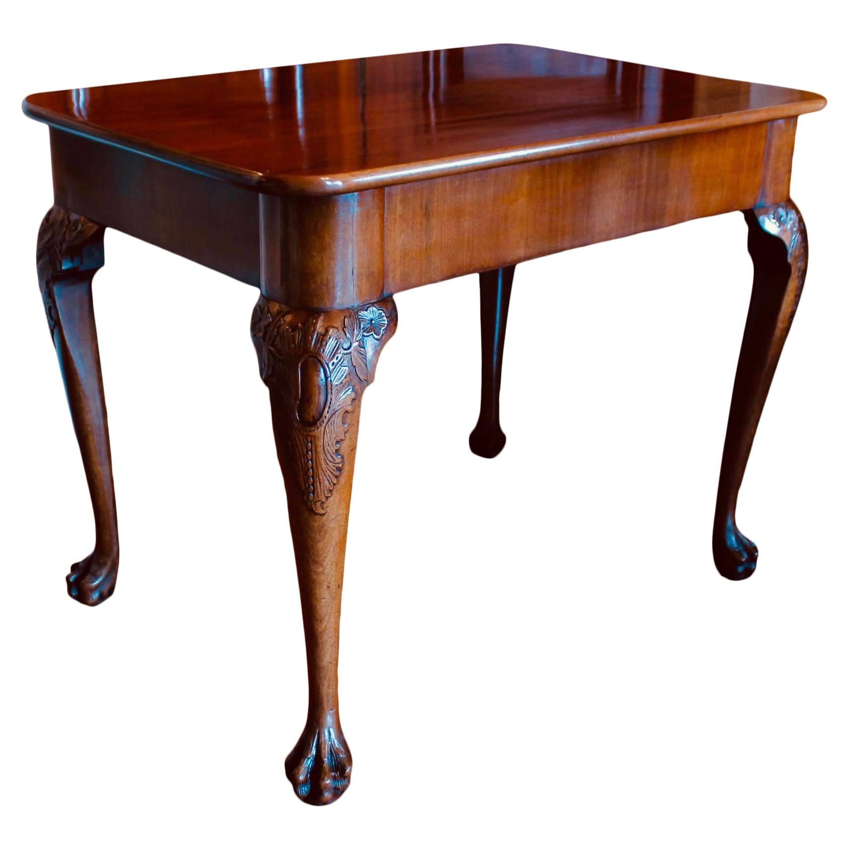 A handsome Georgian mahogany table finished on all four sides, so it can be used freestanding. The table also functions as a console table with one long side having subtle turret corners in the frame to emphasize a front face. The cabriole legs