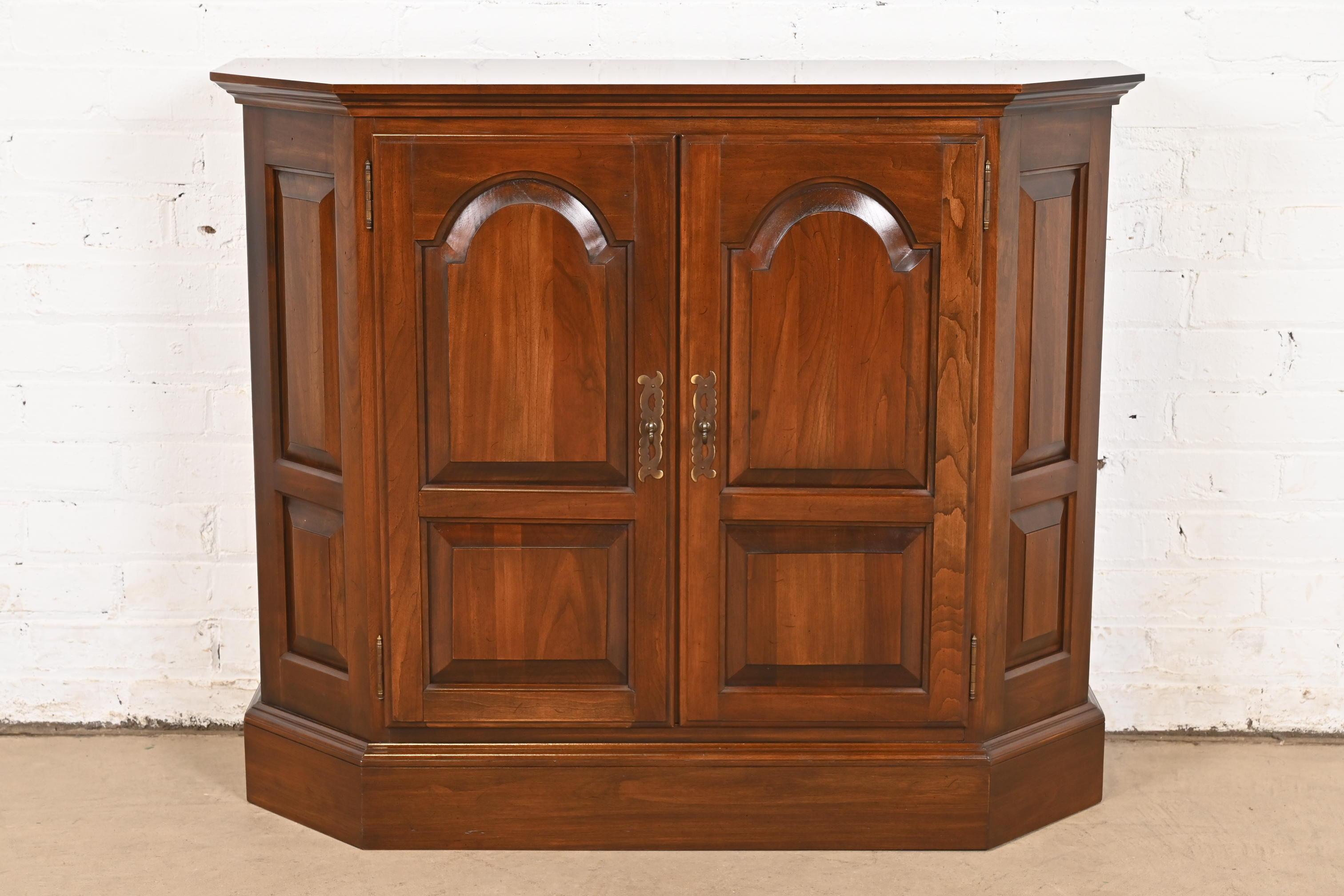 A gorgeous Georgian or Regency style buffet server, console, or bar cabinet

USA, Circa 1960s

Solid carved cherry wood, with original brass hardware. Interior shelf is adjustable.

Measures: 36.25