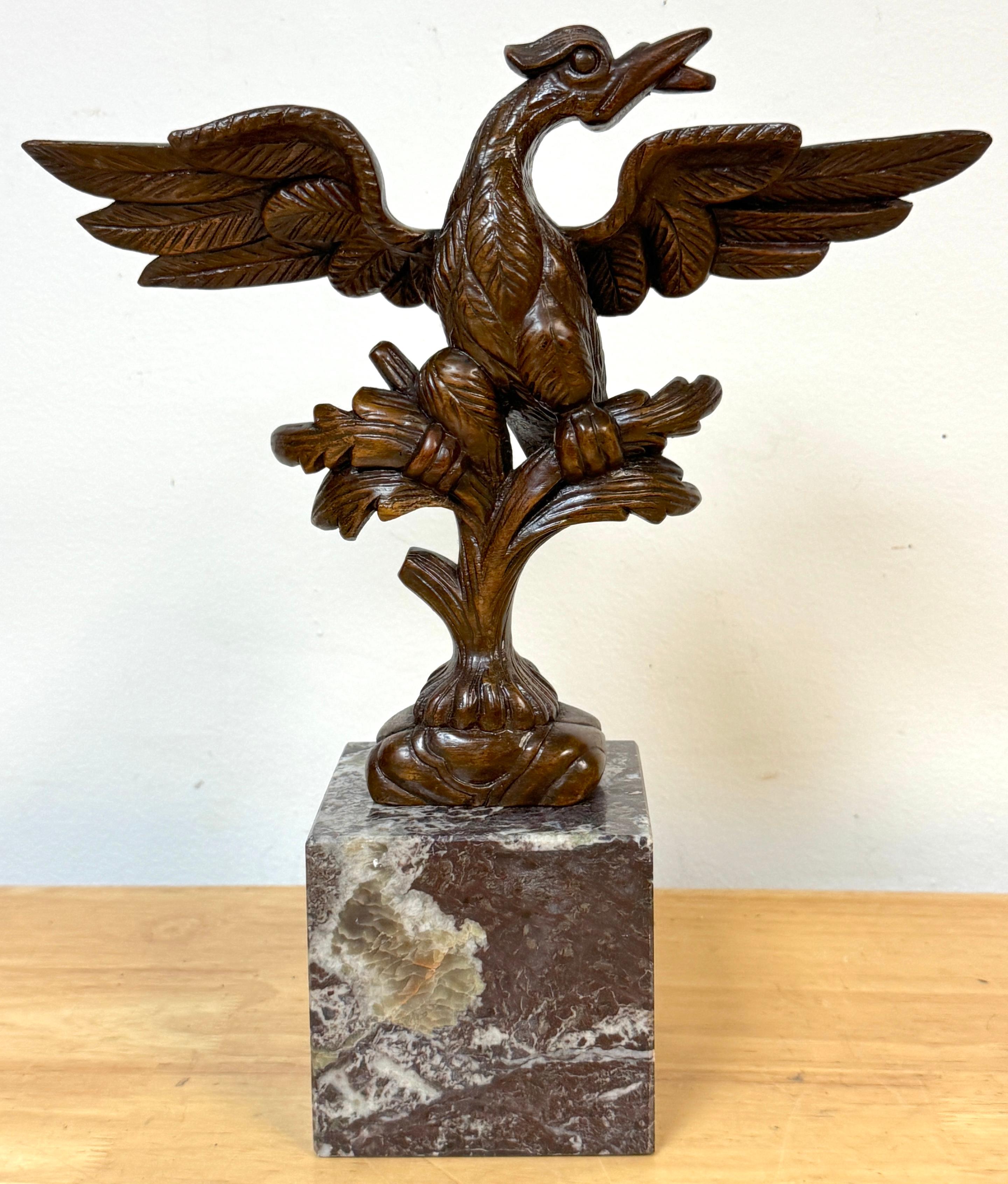 Georgian Carved Mahogany Eagle Ornament, in the Manner of Thomas Chippendale, Mounted on Marble Base, circa 1780–1820

A finely carved Georgian-period mahogany eagle fragment, now mounted on a later variegated marble plinth.  The eagle, with wings