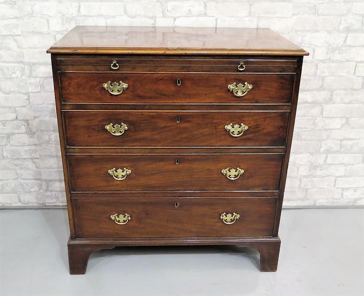 Georgian mahogany chest of drawers of small size with brushing slide above oak lined cock beaded drawers, the fronts with later brass swan neck handles, all set on original bracket feet. Original natural distressed condition with excellent