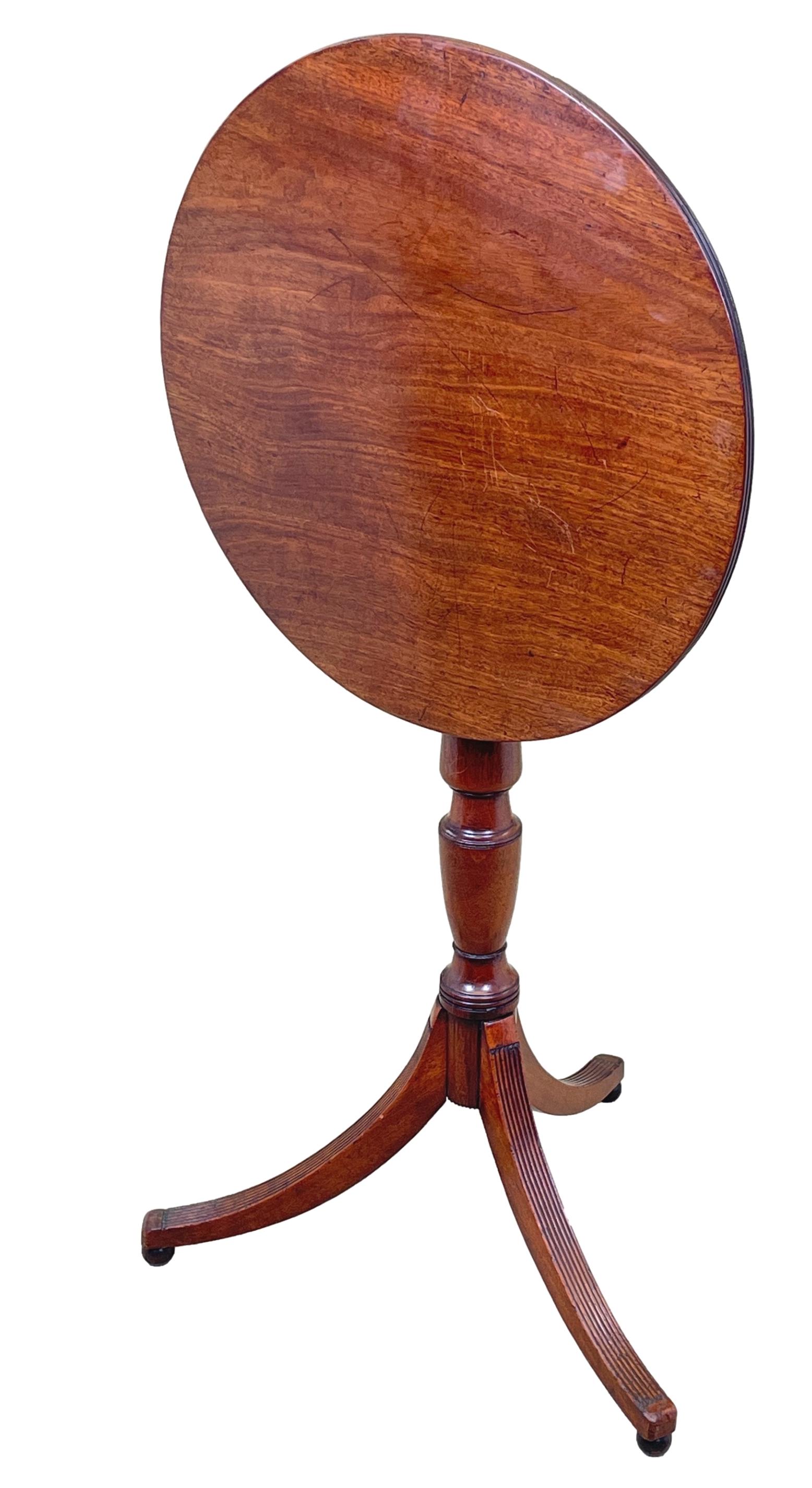 A Good Quality George III Period Mahogany Wine Table, Having Well Figured Circular Tilting Top With Elegant Reeded Edge, Raised On Turned Central Column Terminating With Elegant Reeded Tripod Legs And Turned Ball Feet.


Simple, but effective