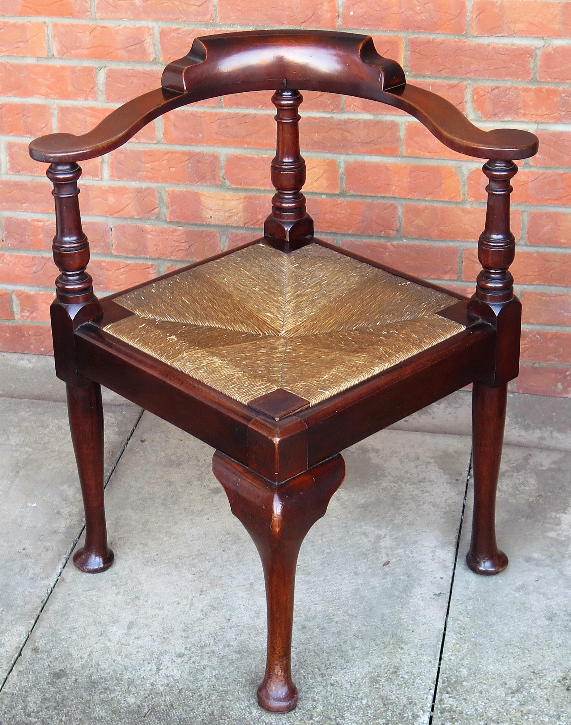 This is a good quality corner chair or armchair handmade from solid hardwood, possibly walnut with a Rush drop-in seat and dating to the 18th century English George 111rd period, circa 1780.

This is a very substantial, strongly handmade chair using