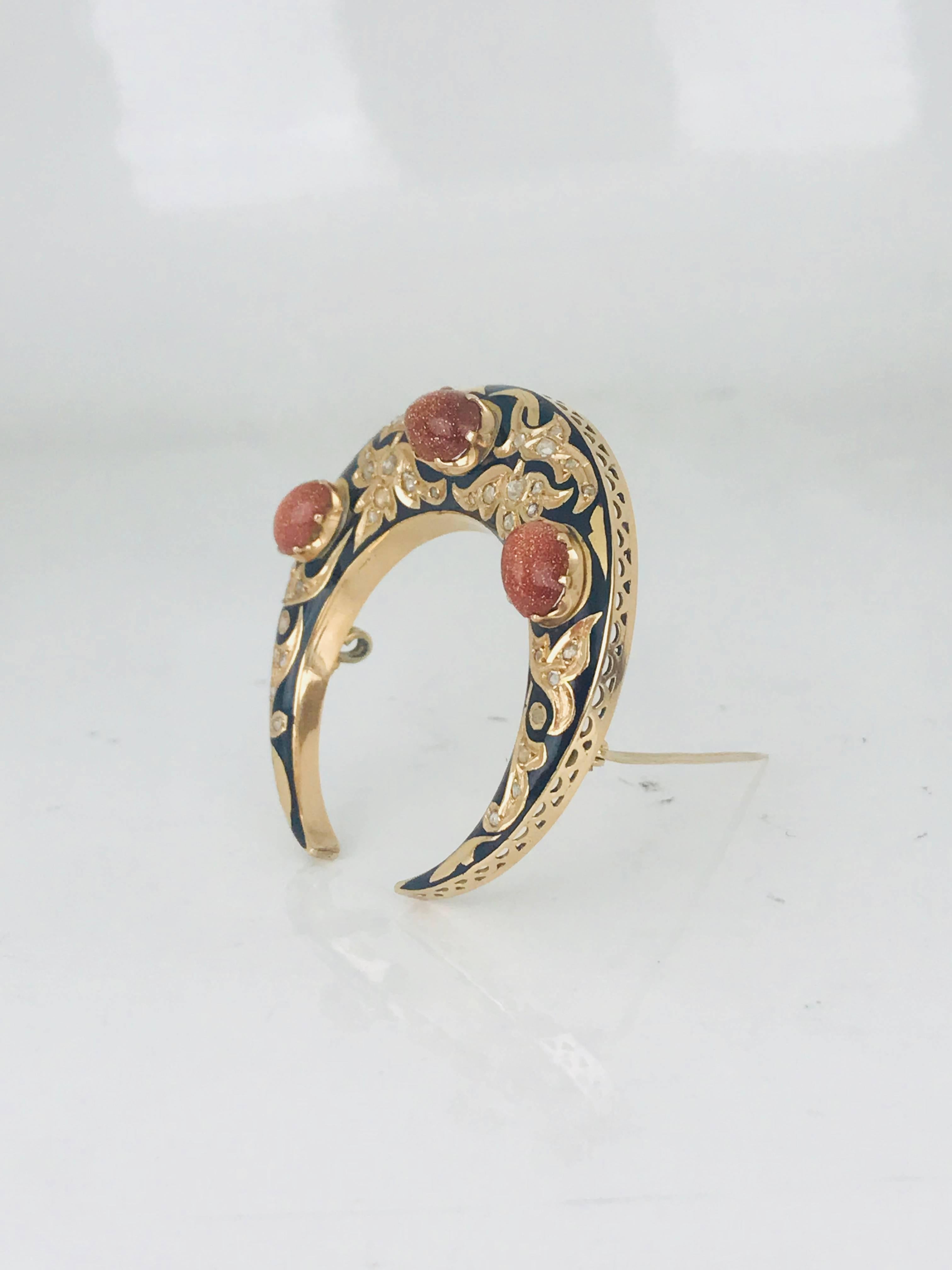 18 karat yellow gold and Enamel, Georgian style Cresent-shaped pin featuring 3 large oval-shaped brown goldstones. Stunning rare vintage pin of beautiful workmanship features 3 large prong-set oval-shaped brown goldstones and 40 old mine cut