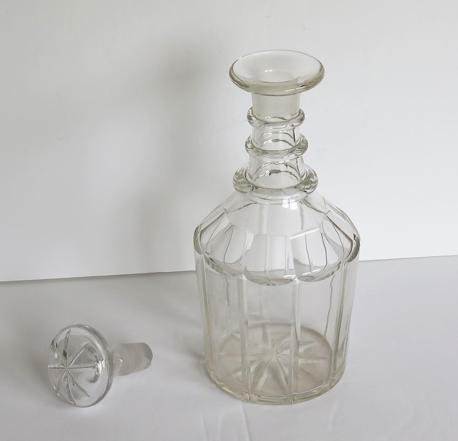 This is a good Anglo-Irish cut-glass or crystal decanter made early in the 19th century, circa 1815, during the English Regency, late Georgian period.

The decanter is nominally straight sided and is beautifully cut in ten broad vertical columns