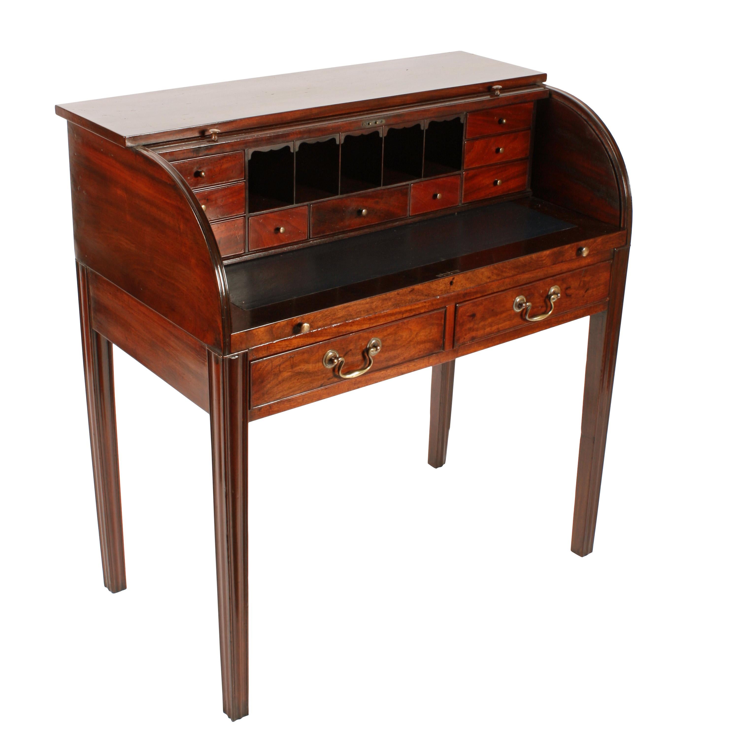 A Georgian mahogany cylinder desk by Gillows of Lancaster.

The desk has two drawers, a slatted mahogany tambour rolling lid, a slide forward writing surface, nine internal drawers and five pigeon holes.

The internal drawers are mahogany