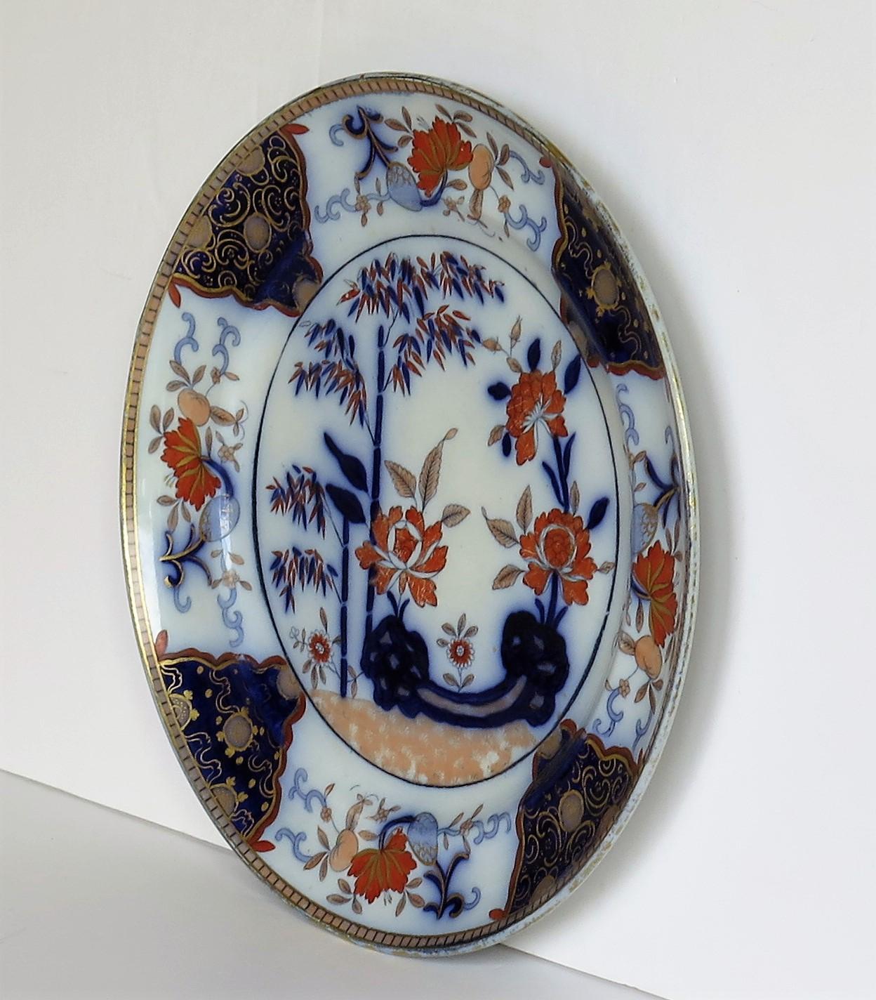 This a good large dinner plate made by William Davenport & Co., Longport, Staffordshire Potteries, England, circa 1810-1820.

The plate is hand painted over a printed outline in a bold Chinoiserie pattern No. 136. The design highlights a bamboo