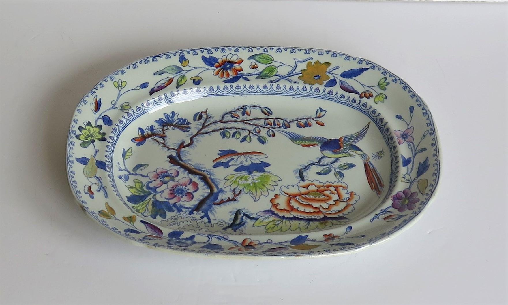 This is a good hand painted ironstone ( stone china) platter, made by William Davenport and Co., Longport, Staffordshire Potteries, England, circa 1820.

The platter is well potted and hand painted, probably over a blue printed outline, in