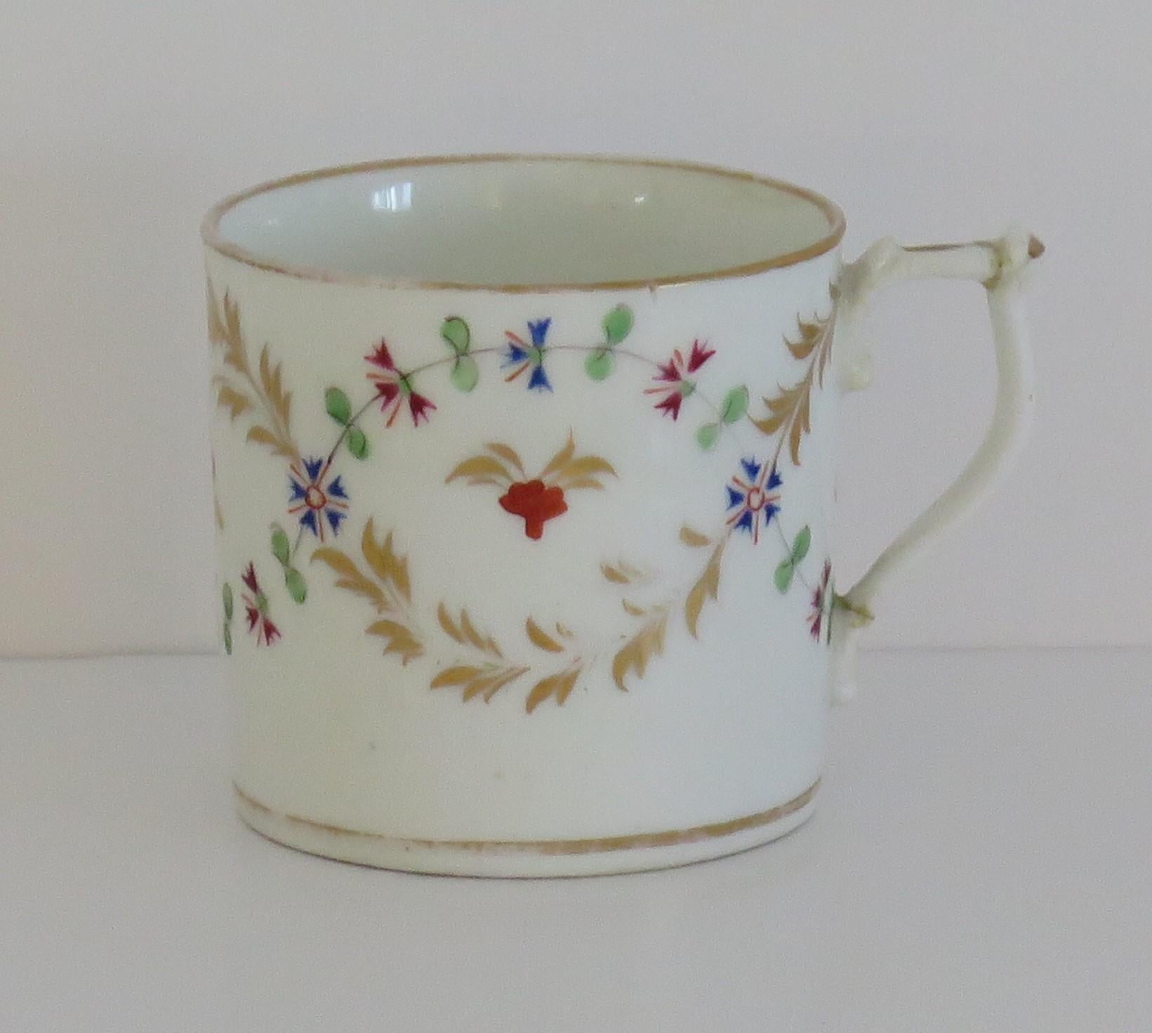 This is a beautiful porcelain Coffee Can by the Derby factory, made during the late Georgian period of the early years of the 19th Century

The cylindrical can tapers slightly to the base and has a wishbone handle.

The decoration is exquisite, all