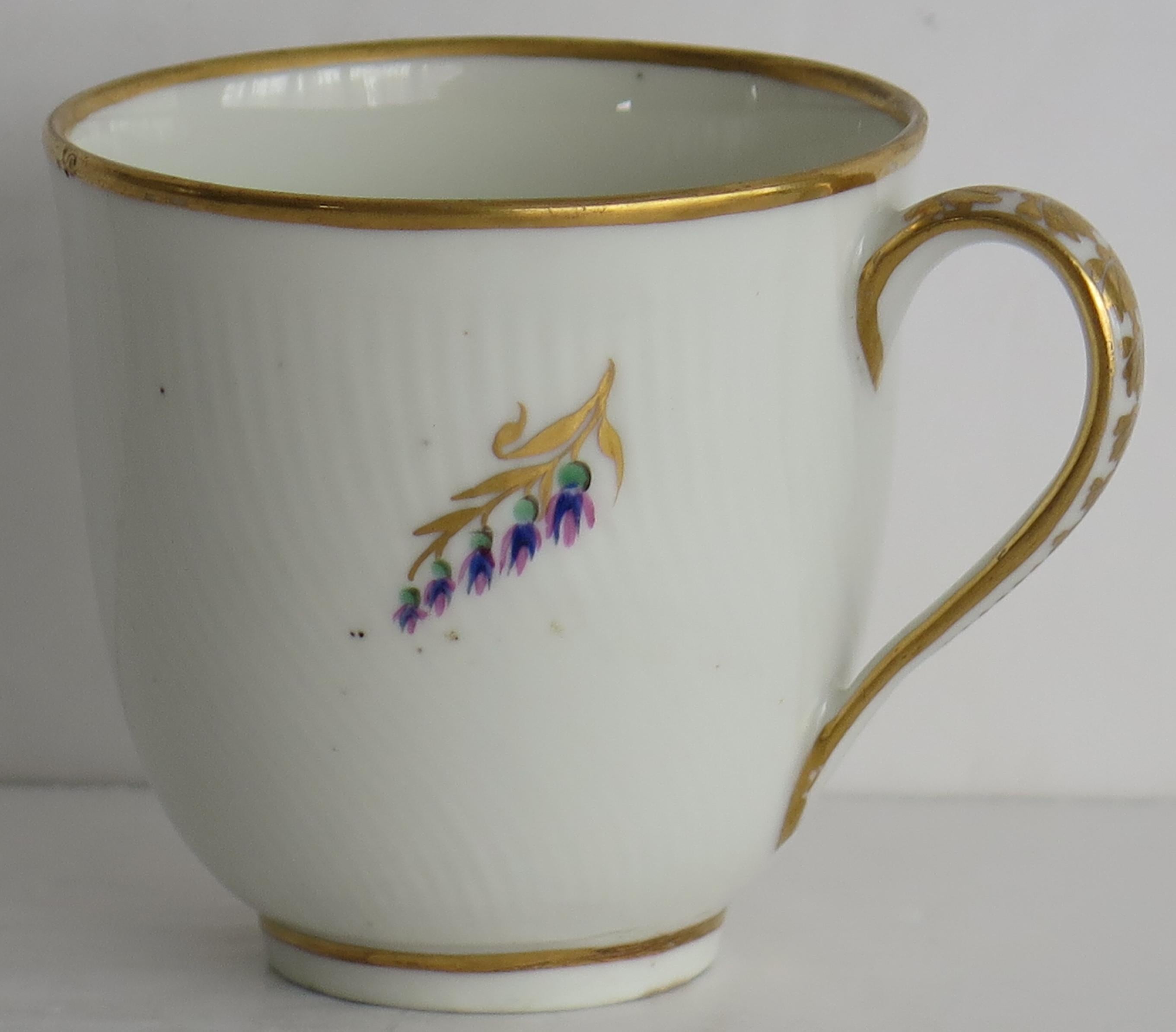This is a very good early coffee cup by the Derby factory, made in the late 18th century, George 3rd period, circa 1785.

The body of the cup has incised vertical twist flutes and sits on a low foot, with a plain loop handle.

It is beautifully