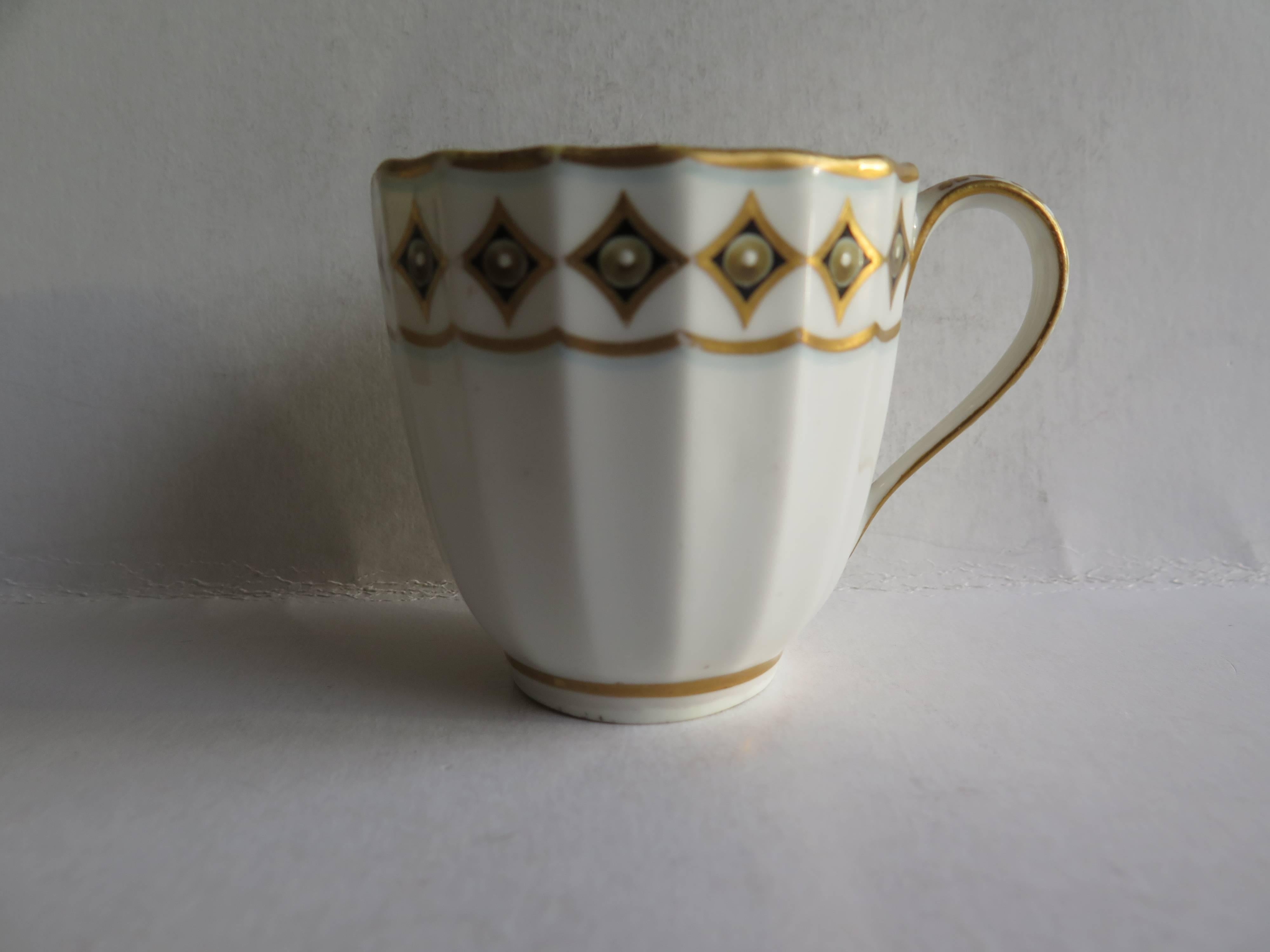 This is a very good early coffee cup by the Derby factory, made in the late 18th century, George 3rd period, circa 1790.

The body of the cup has 16 vertical flutes and has a plain loop handle.

It is decorated with gilt rims with the outer rim
