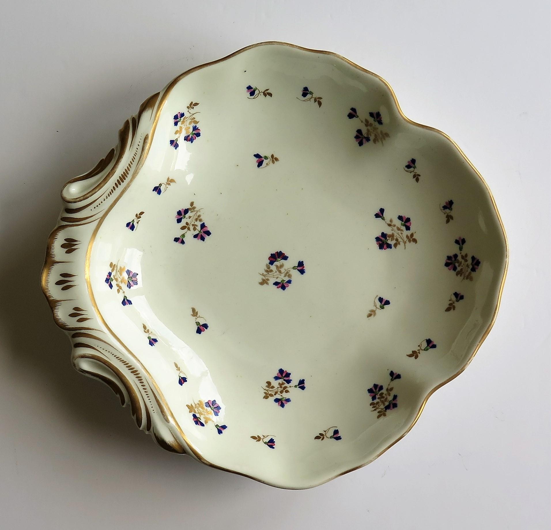 This is a beautiful porcelain shell dish or plate hand painted and gilded in pattern 129, made by the Derby factory, in the reign of George 111 in the early 19th century, circa 1810.
 
Shell dishes, named as such for taking the shape of a shell were