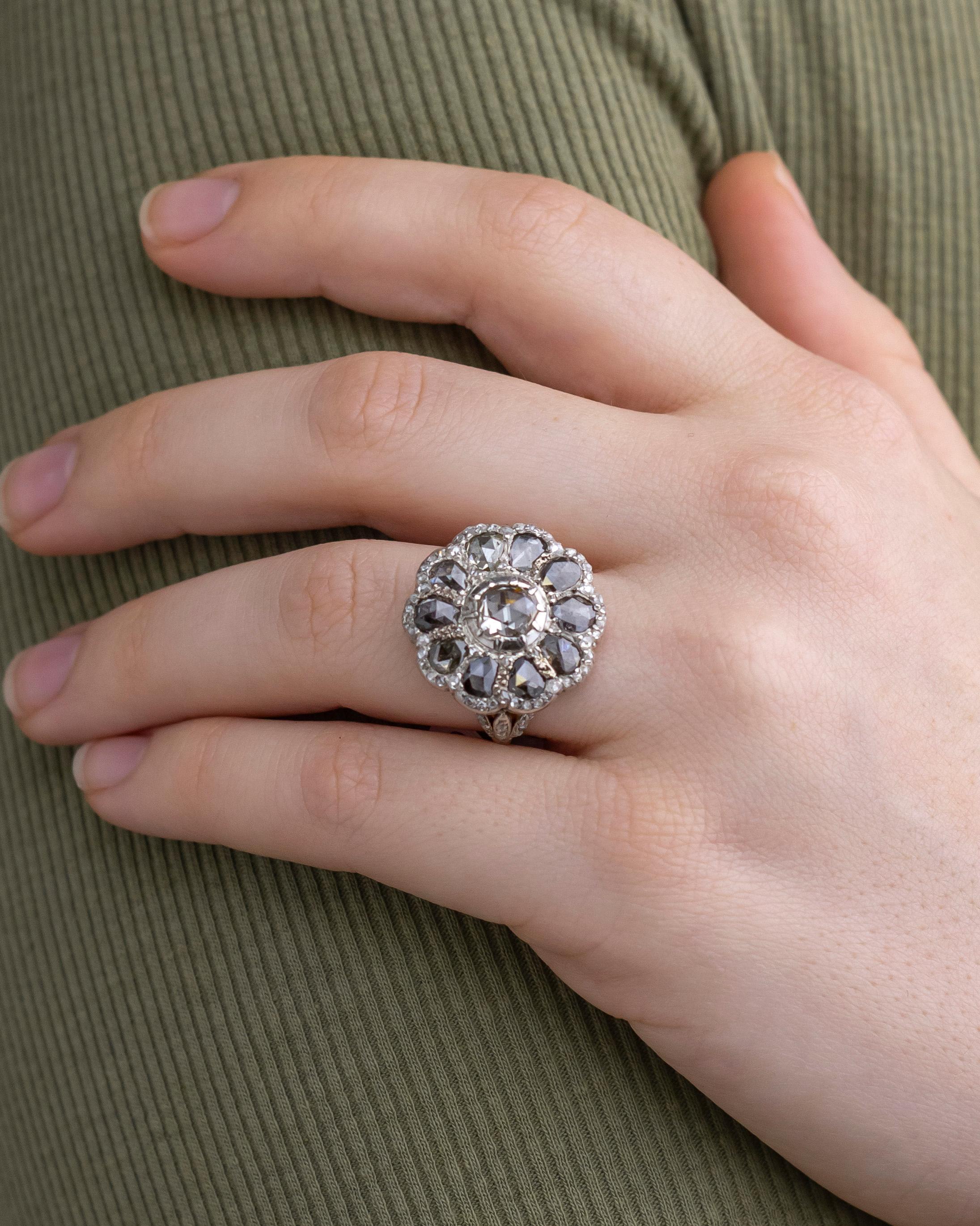This exceedingly rare jewel has been converted to be a ring from what was an 18th century Georgian diamond button. The posy type cluster of diamonds are set within 14 karat yellow gold and silver. This 'button' was delicately altered to become a