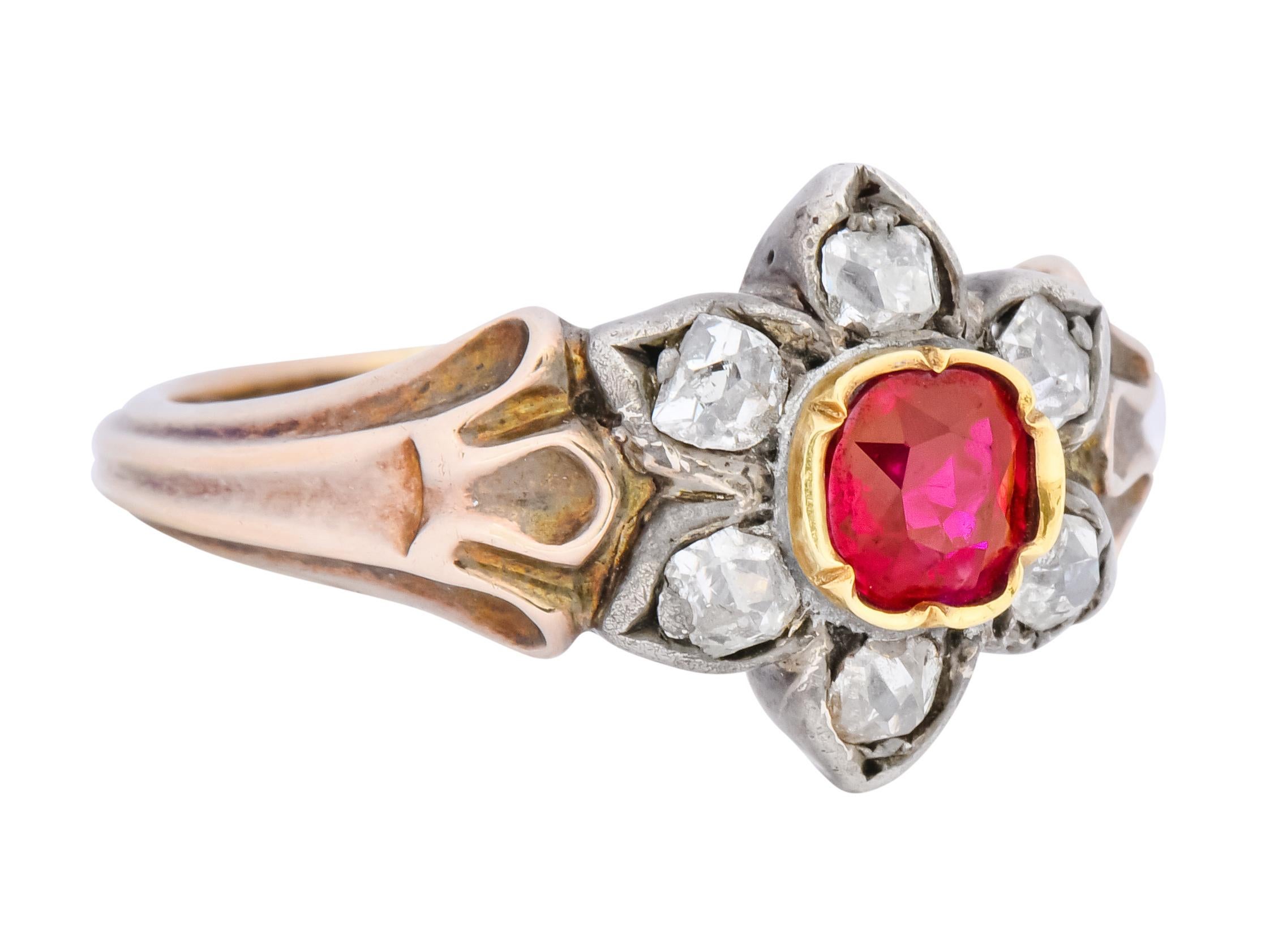 Cluster style ring centering a cushion cut ruby weighing approximately 0.75 carat total, graver set within a polished gold surround, transparent and vividly red in color

Surrounded by old mine cut diamonds, set as silver petals, weighing 0.42 carat