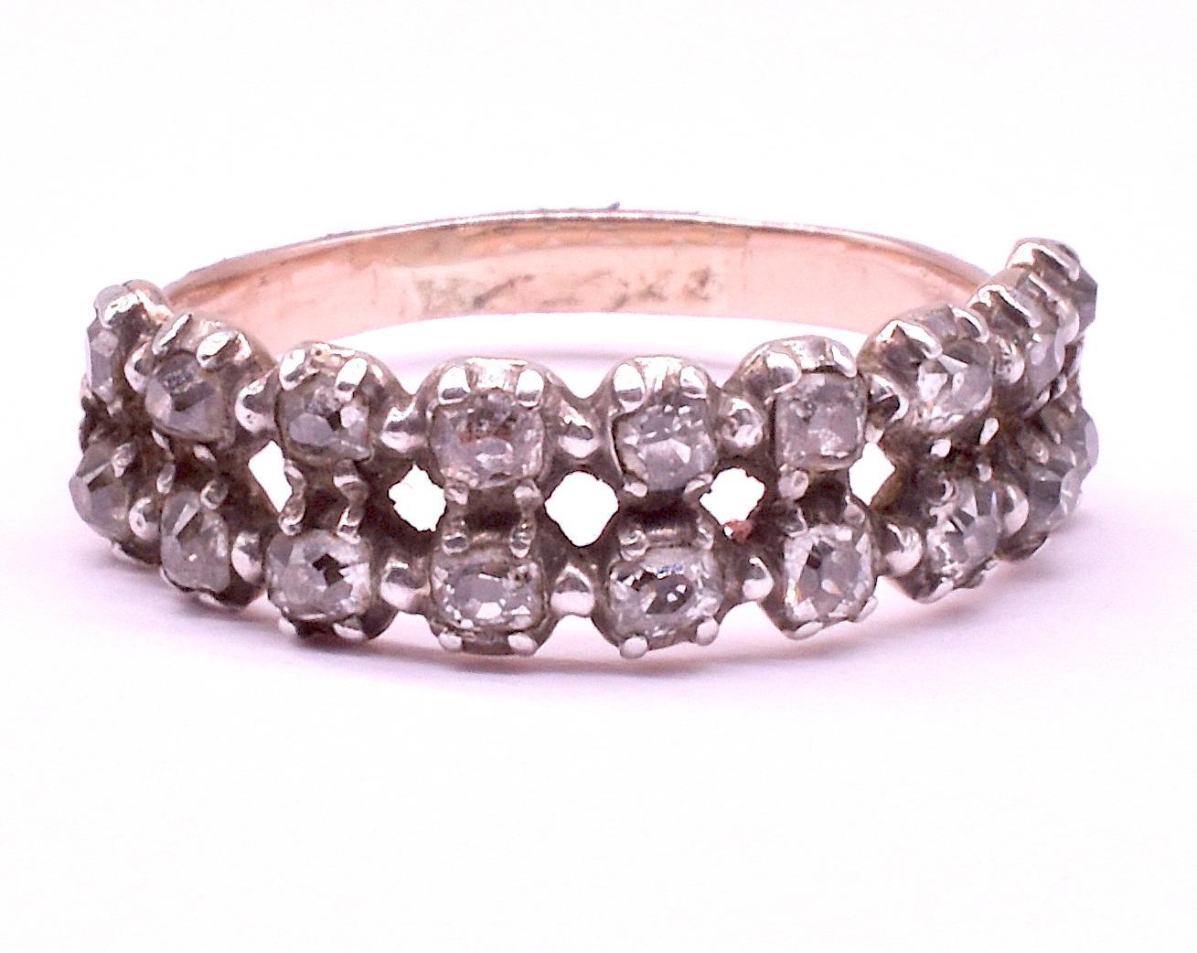 Circa 1810, this wonderful 18K half hoop closed back ring has a double row of brilliant-cut diamonds and a delightful diagonal crimping detail along each side of the band. This ring marries well with others or looks wonderful alone with its