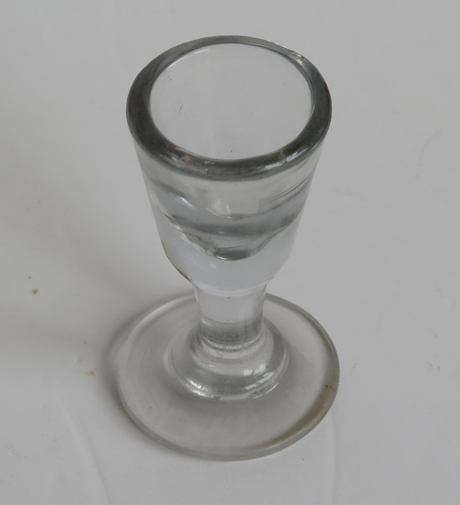 This is a very good English hand blown, Georgian drinking dram glass, which we date to the turn of the 18th Century, Circa 1800. 

This glass is individually hand blown, from lead glass which is characterised by its soft grey colour, its fairly