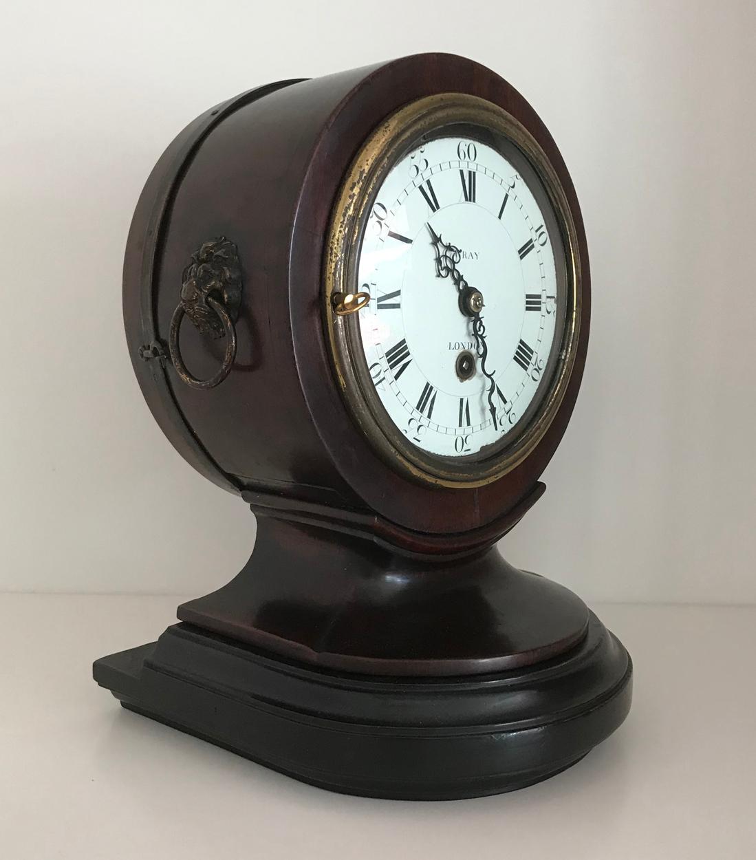 An 18th century walnut cylindrical cased mantel timepiece, signed Wray of London, the 6ins diameter white enamel dial with Roman and Arabic numerals, to the eight day single train verge movement, contained in plain cylindrical case with gilt brass