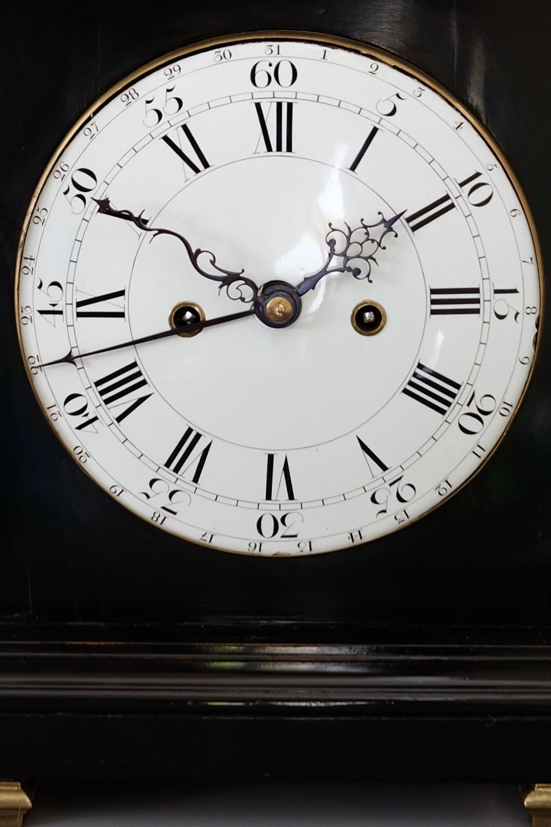 A stunning antique George III ebonised eight day striking bracket clock with enamel dial and verge escapement. Twin fusee movement with verge escapement striking and repeating the hours on a bell.

The brass mounted bell-top case with brass fitted