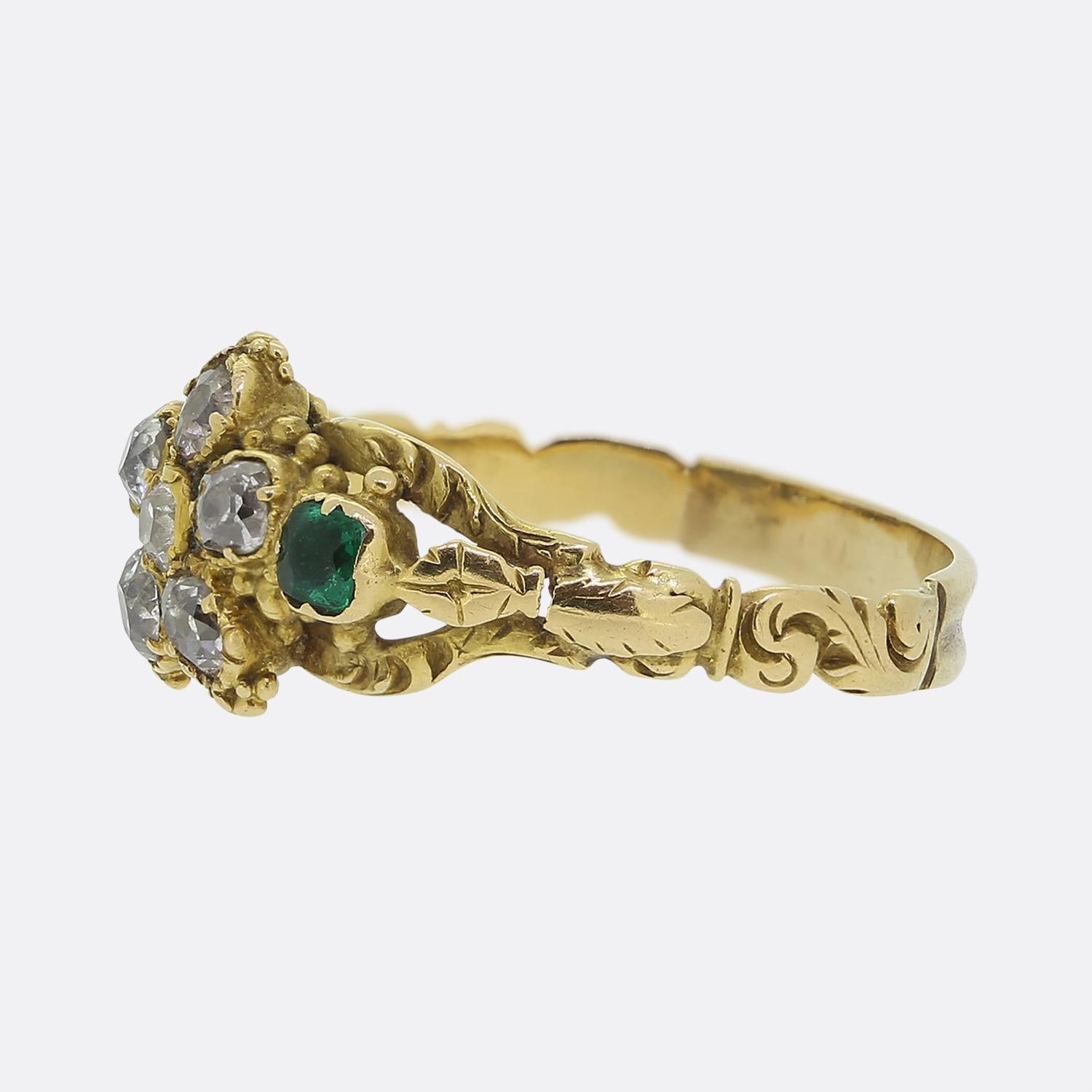 Here we have a delightful cluster ring taken from the Georgian period. The centre of the face features a floral arrangement of old mine cut diamonds with their white hue beautifully contrasted by a single vibrant green emerald at either side. Each