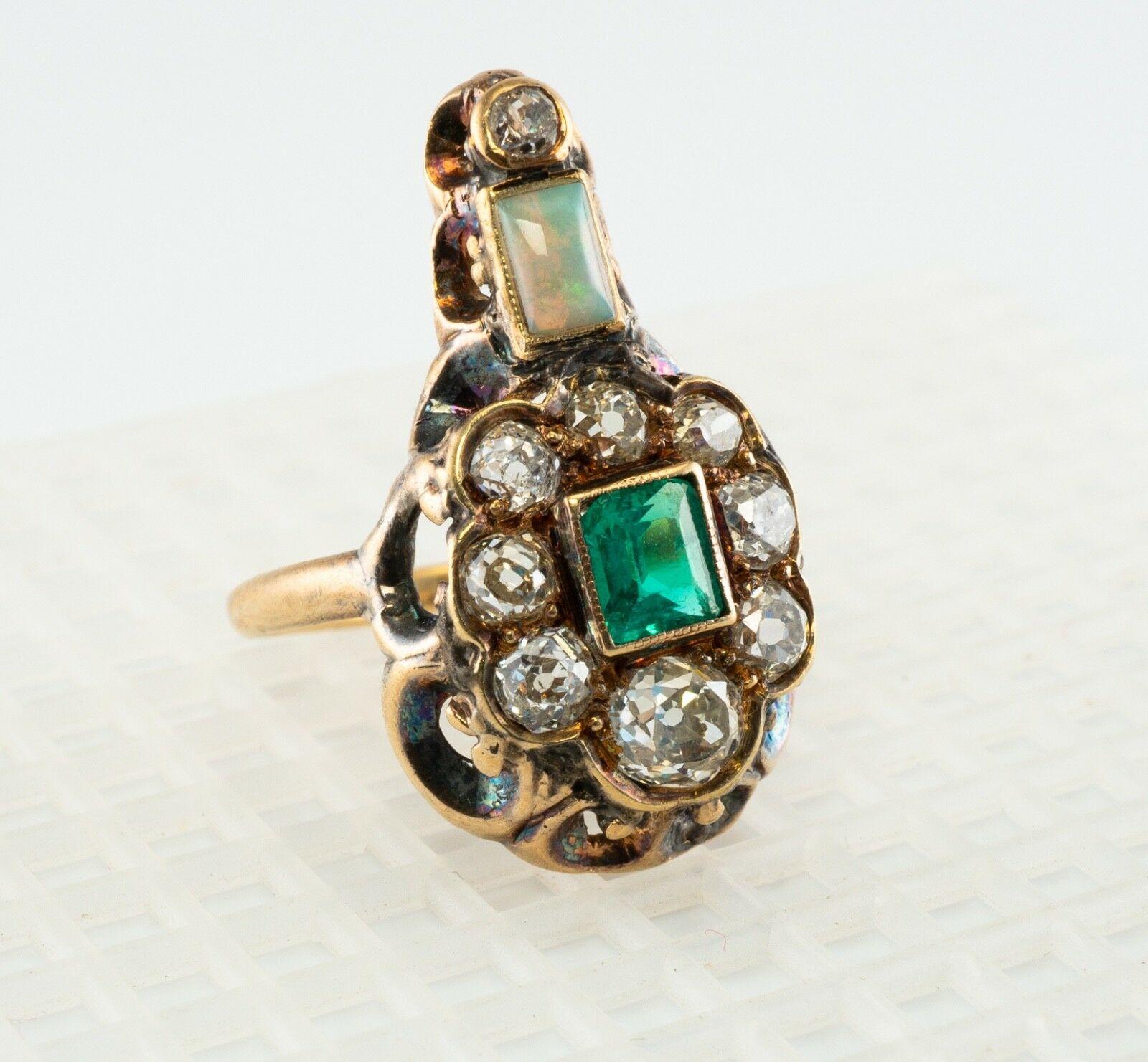 This rare and highly collectible antique ring is finely crafted in solid 14K Yellow gold (carefully tested and guaranteed). All gemstones in this ring are original to the setting. The center genuine Earth mined Colombian Emerald measures 4.5mm x 4mm
