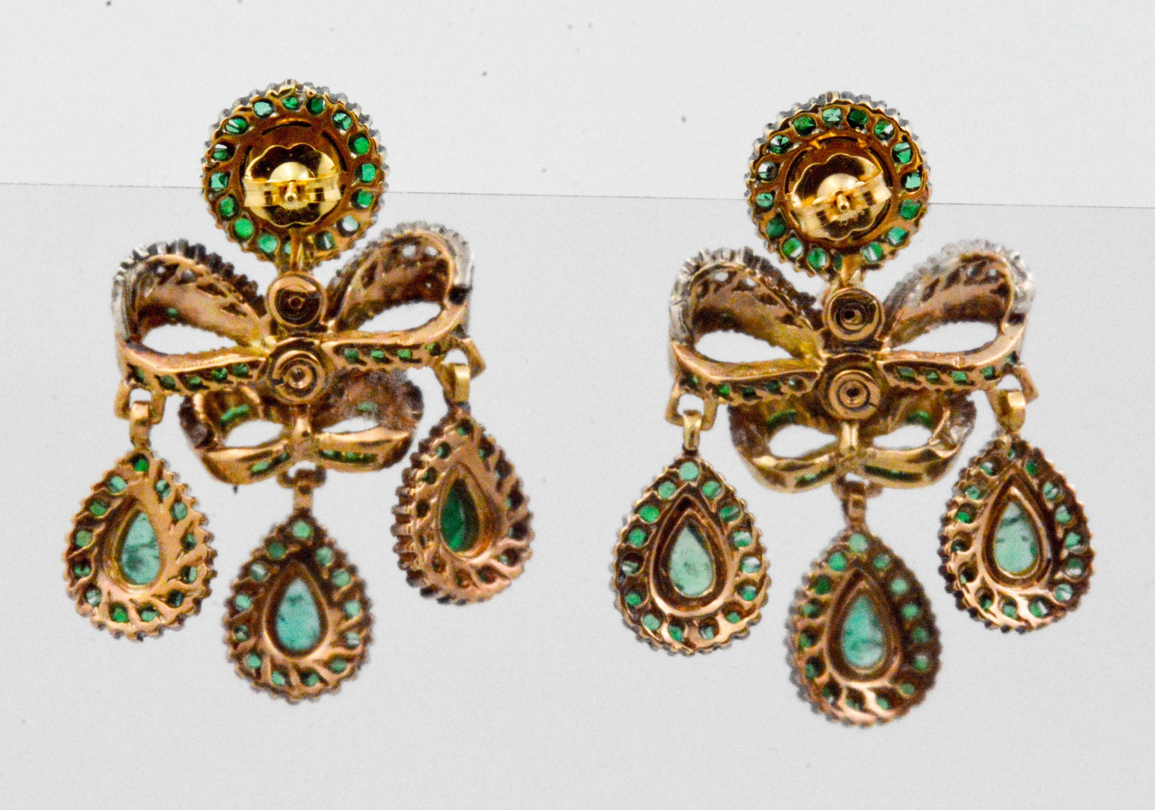 This vintage pair of Georgian earrings have a story to tell. Created during the 1780's, these emerald and European cut diamond earrings are in incredible condition. Crafted in 14 karat gold and silver, three tear drops of emeralds and diamonds