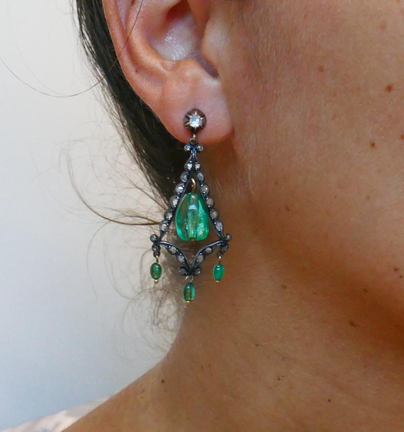 Beautiful earrings featuring beaded emeralds set in silver and 10 karat yellow gold and accented with rose cut diamonds.  
Measurements: 2 x 7/8 inches ( 5  x 2 cm).
Weight: 8.9 grams.
The earrings come in an original antique box.
Understated,