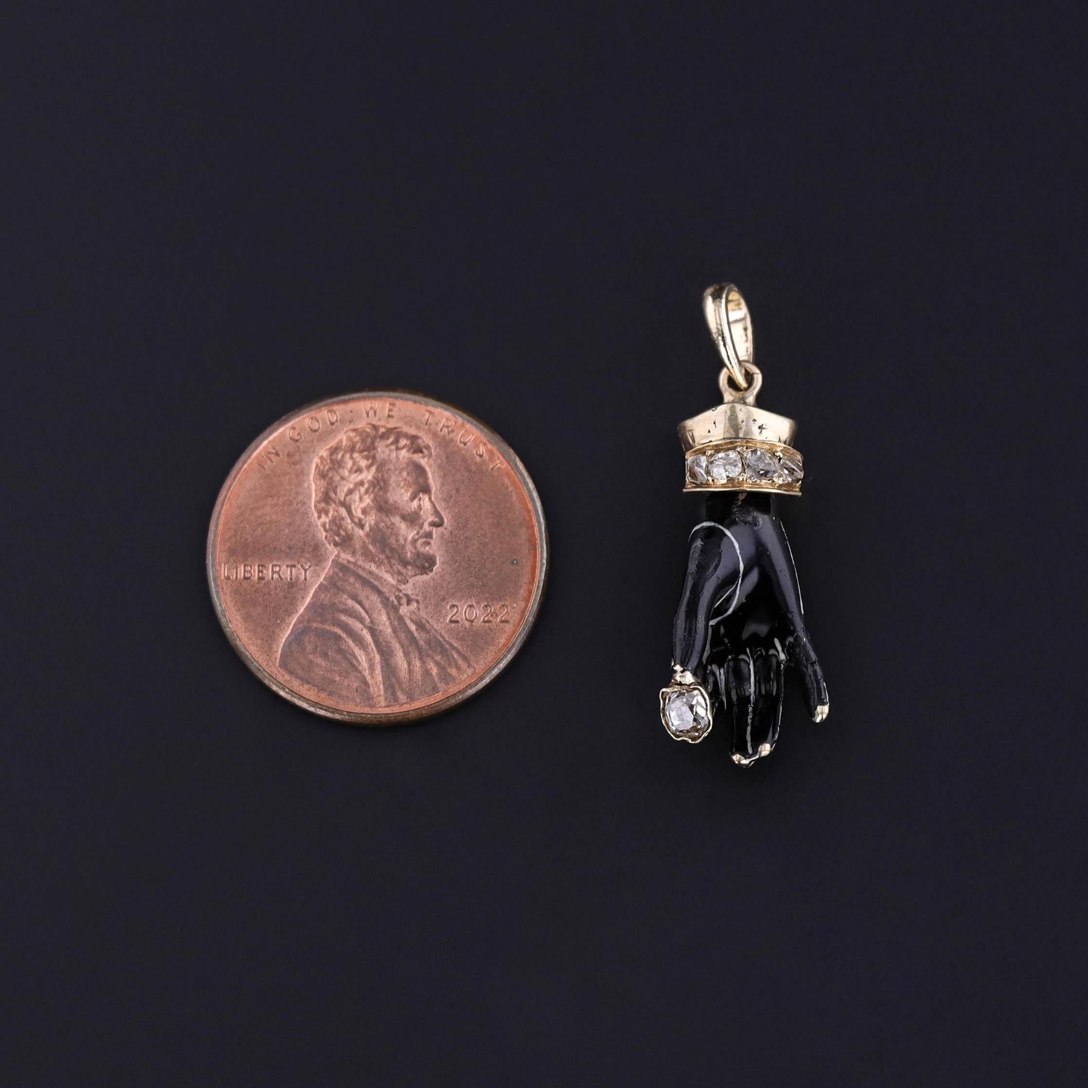 Steeped in symbolism and elegance, this Georgian era pendant (circa 1830) features a finely crafted hand motif rendered in black enamel over solid 14k gold, accented with a sparkling array of rose cut and old cut diamonds. The hand—a popular symbol