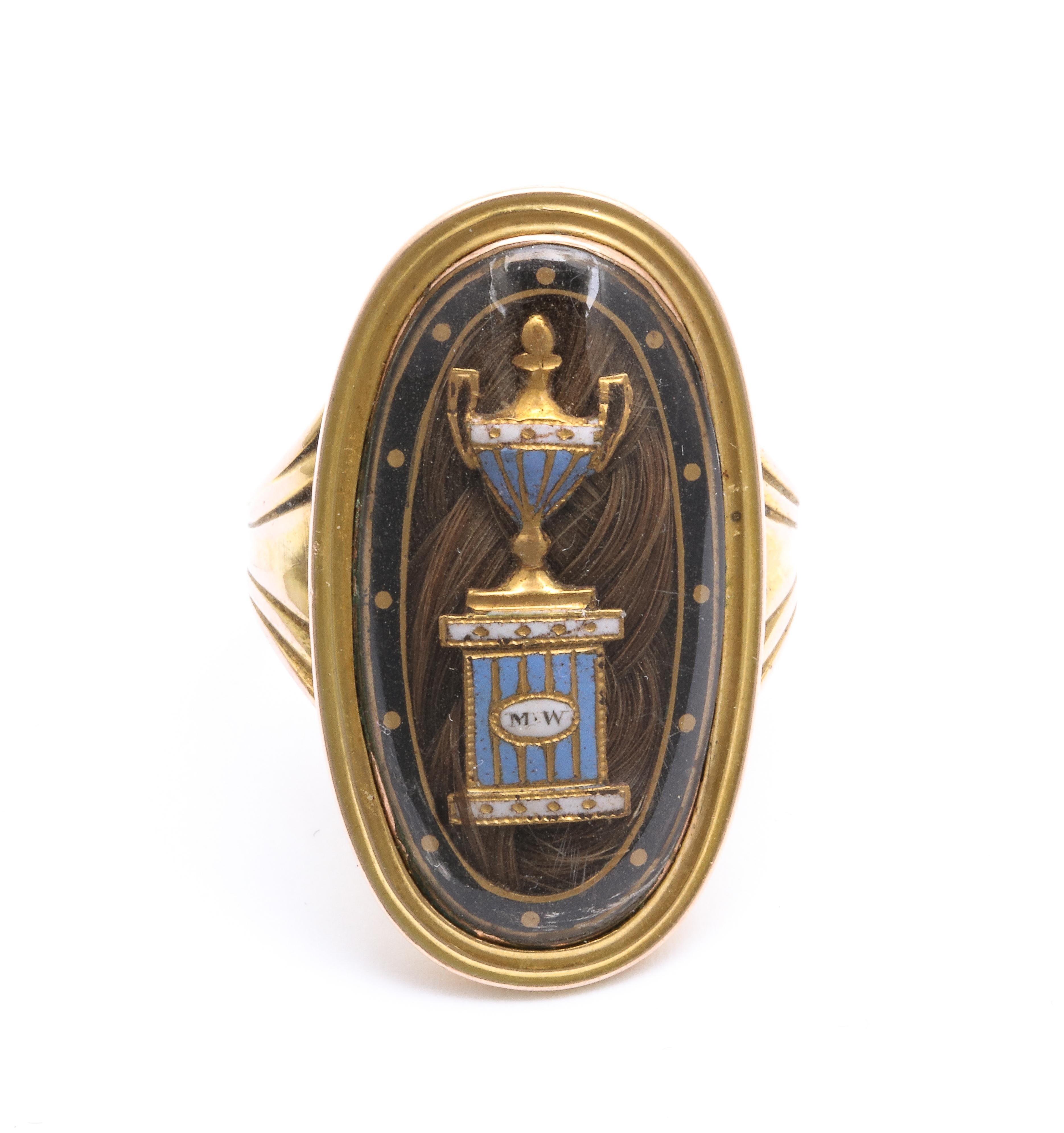 Georgian rings such as this, made in 1792, are curved to fit perfectly to your finger. This marvelous example is 15 KT gold with a fine inner frame of dark brown enamel on which gold dots travel the perimeter. Under the crystal is a gold and light